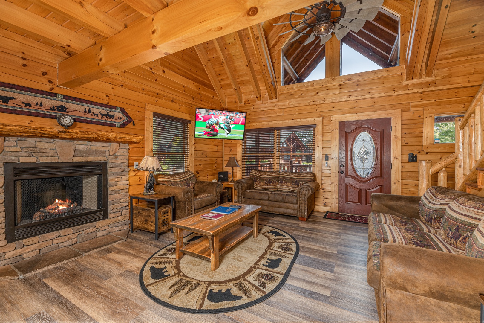 Living room with fireplace and TV at Loving Every Minute, a 5 bedroom cabin rental located in Pigeon Forge