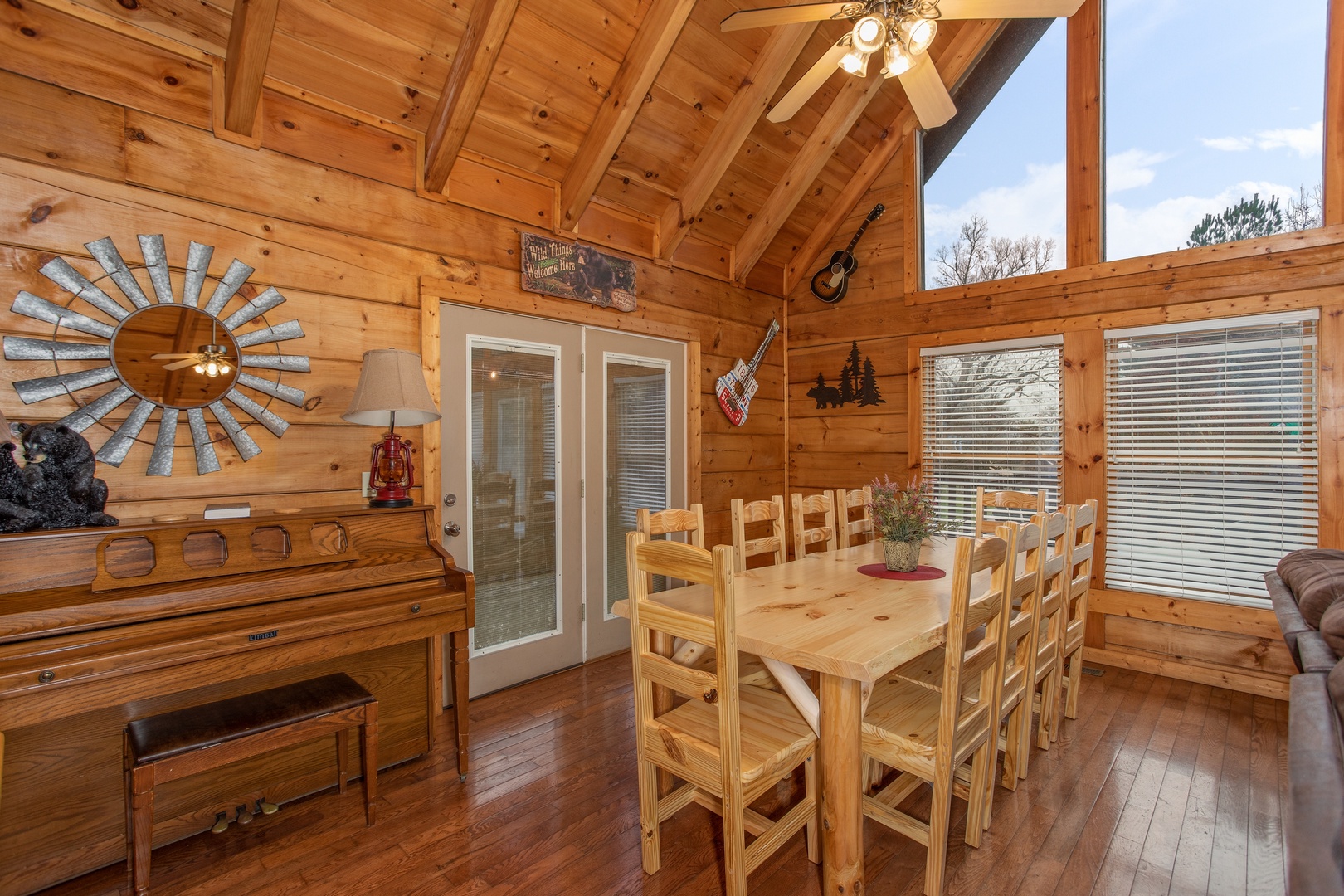 Piano and dining table for ten at Mountain Music, a 5 bedroom cabin rental located in Pigeon Forge