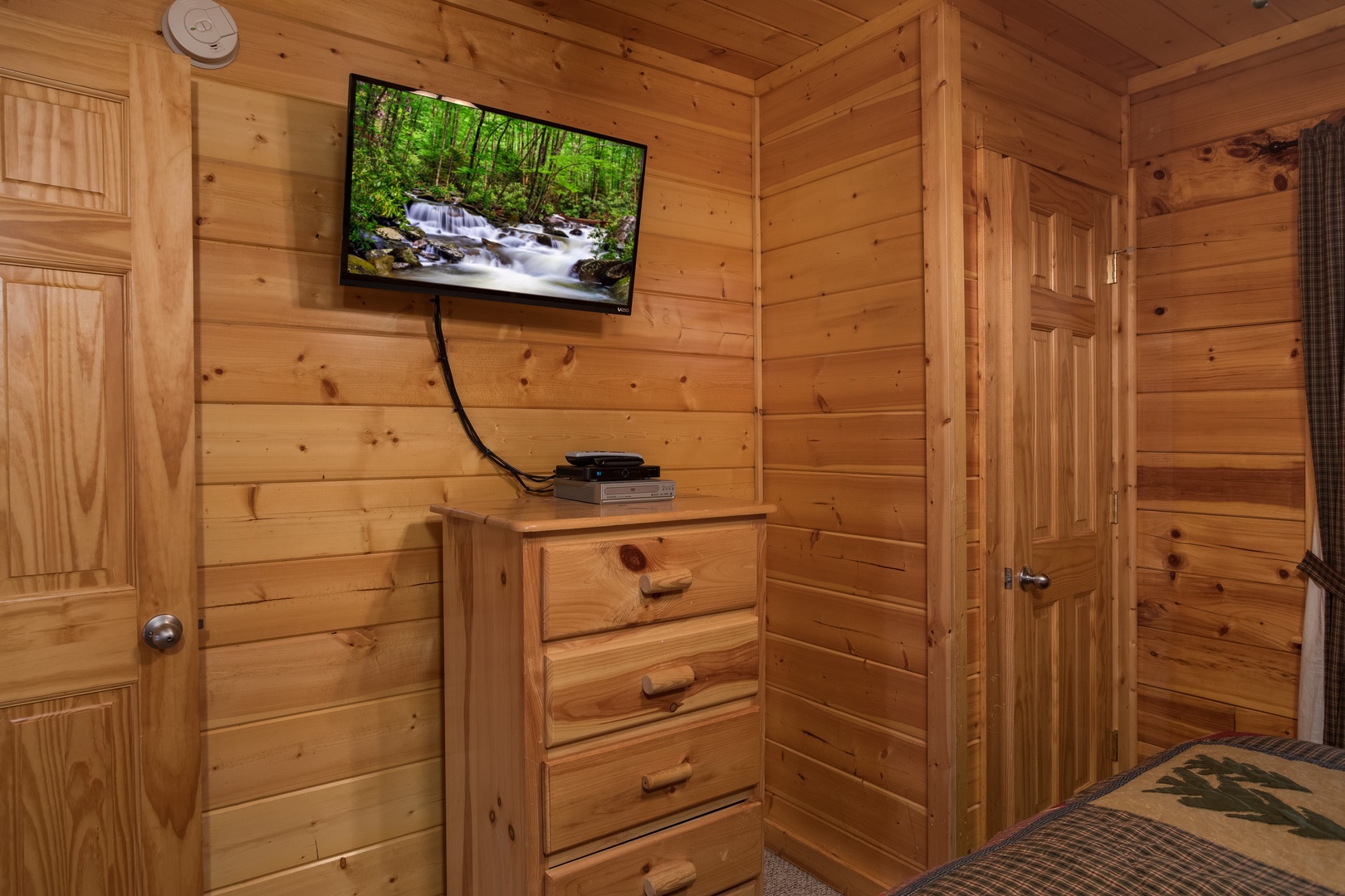 Dresser and TV in a bedroom at Kick Back & Relax! A 4 bedroom cabin rental located in Pigeon Forge