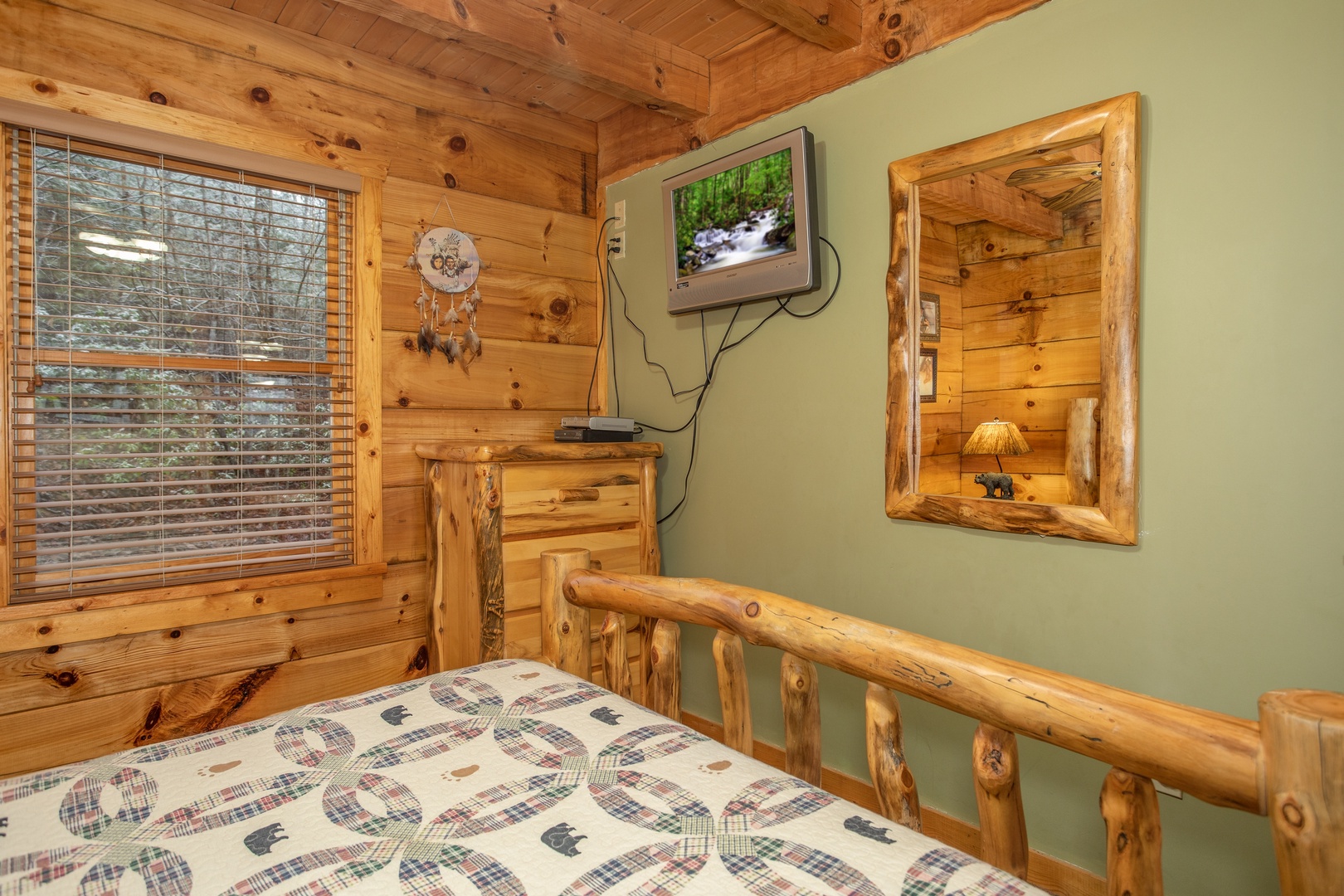 Queen bedroom with a dresser and TV at Alpine Romance, a 2 bedroom cabin rental located in Pigeon Forge