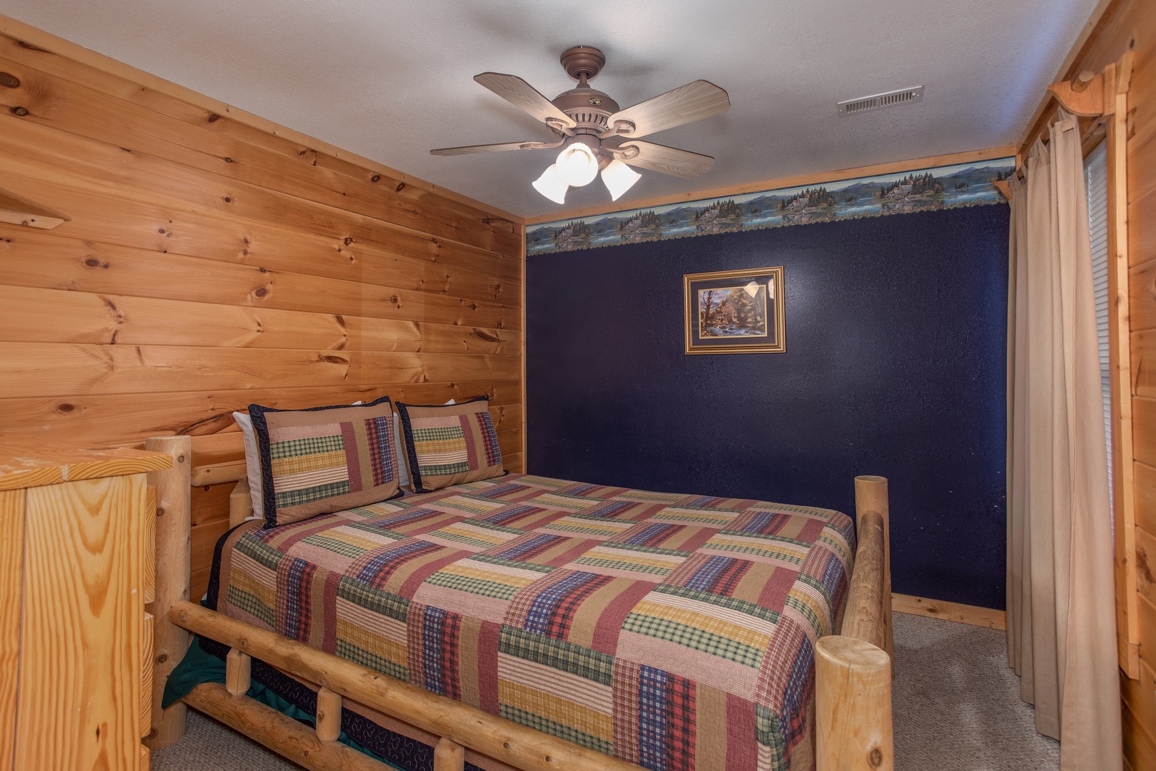 Queen-sized bed in a bedroom at Bearly in the Mountains, a 5-bedroom cabin rental located in Pigeon Forge