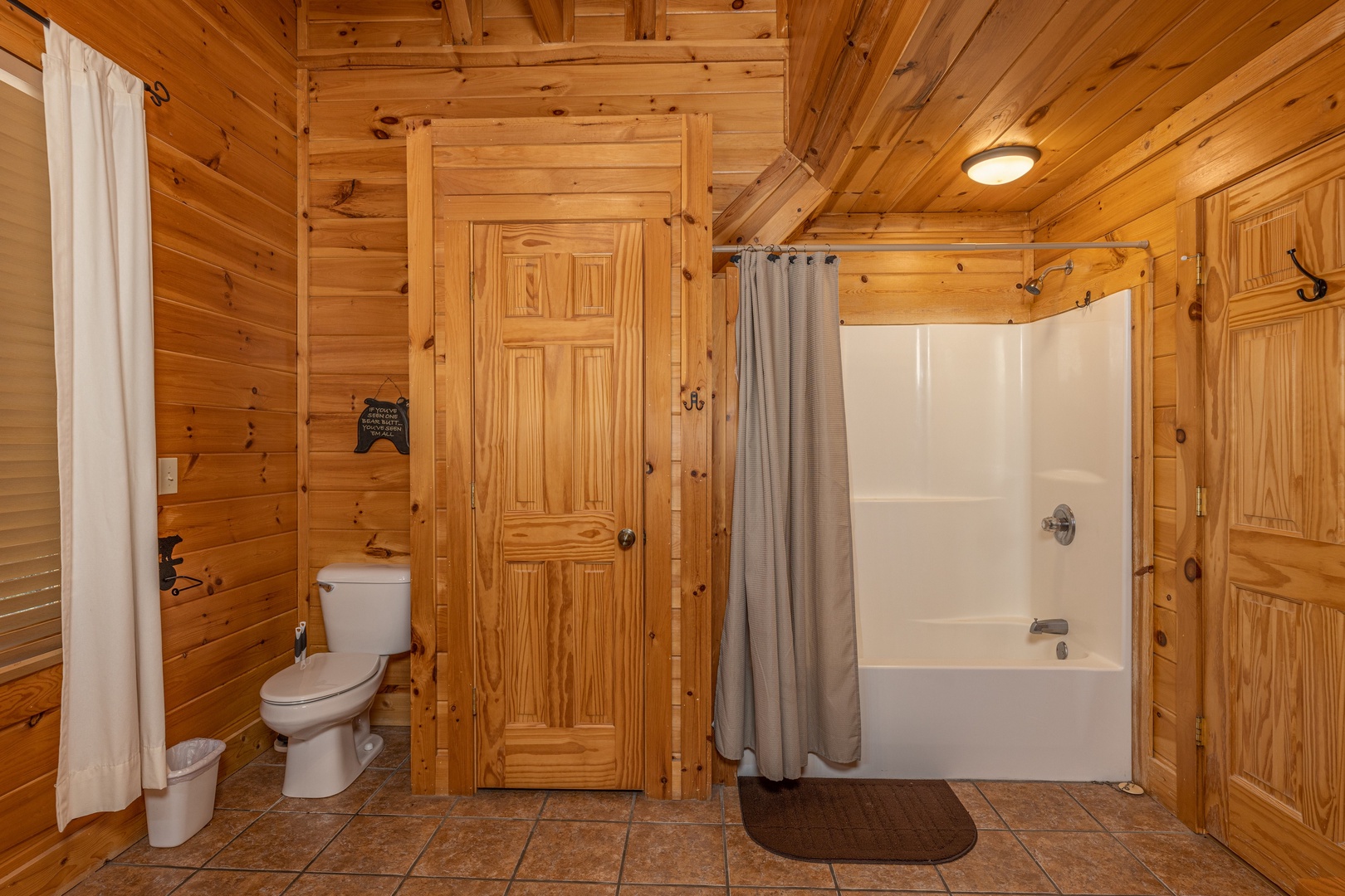 Bathroom with a tub and shower at Bears Don't Bluff, a 3 bedroom cabin rental located in Pigeon Forge