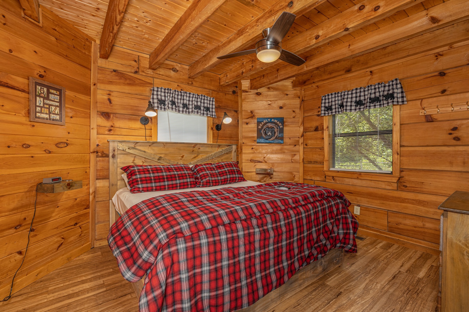 King bed and dresser in a bedroom at Honeymoon in Gatlinburg, a 1 bedroom cabin rental located in Gatlinburg