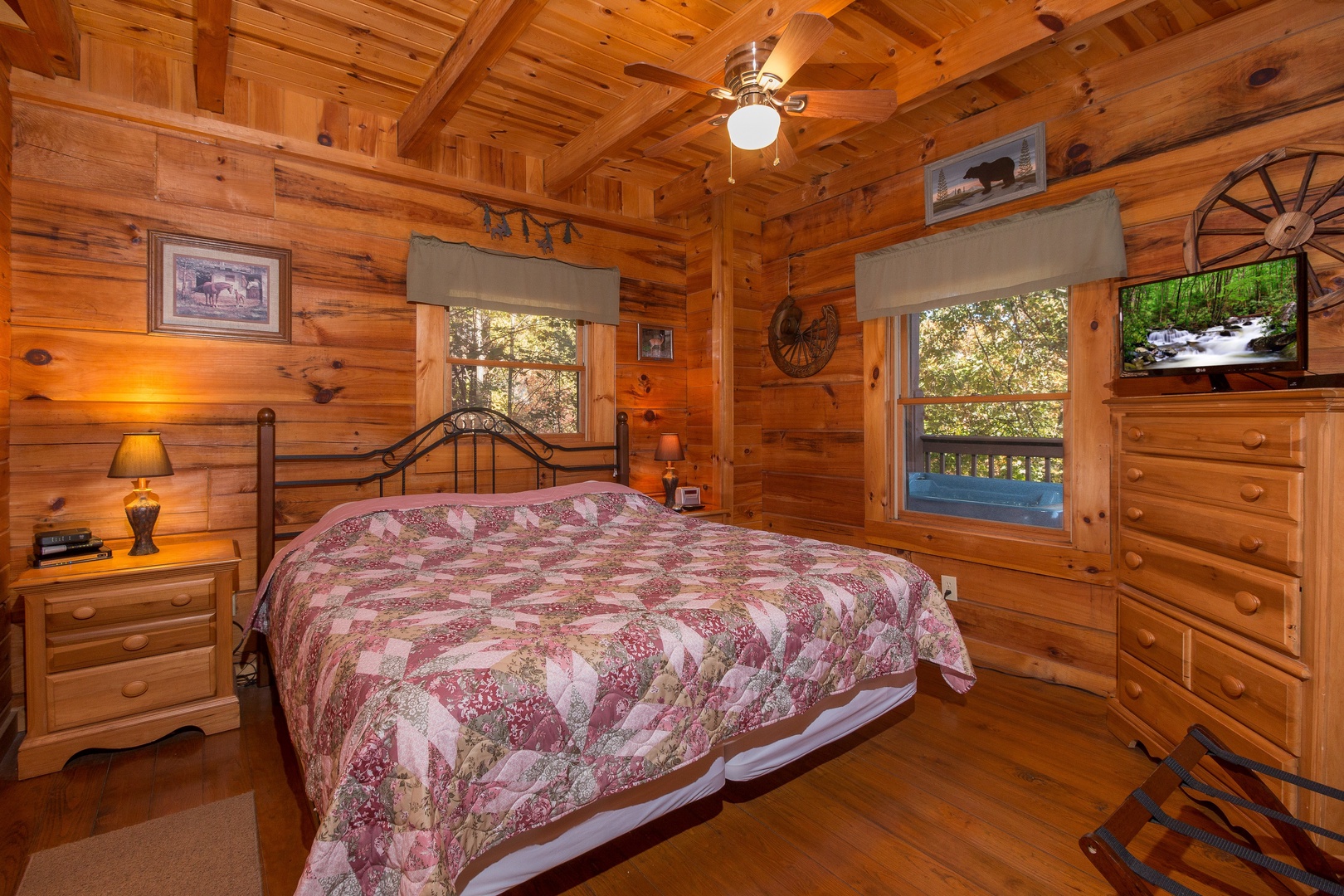 Bedroom with a king bed, night stands, and lamps at Hawk's Nest, a 1 bedroom cabin rental located in Pigeon Forge