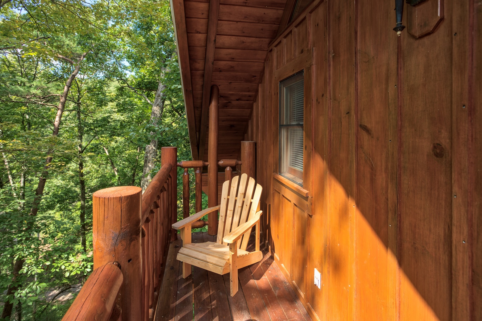 Deck off the game room at Dreams Do Come True, a 1-bedroom cabin rental located in Pigeon Forge