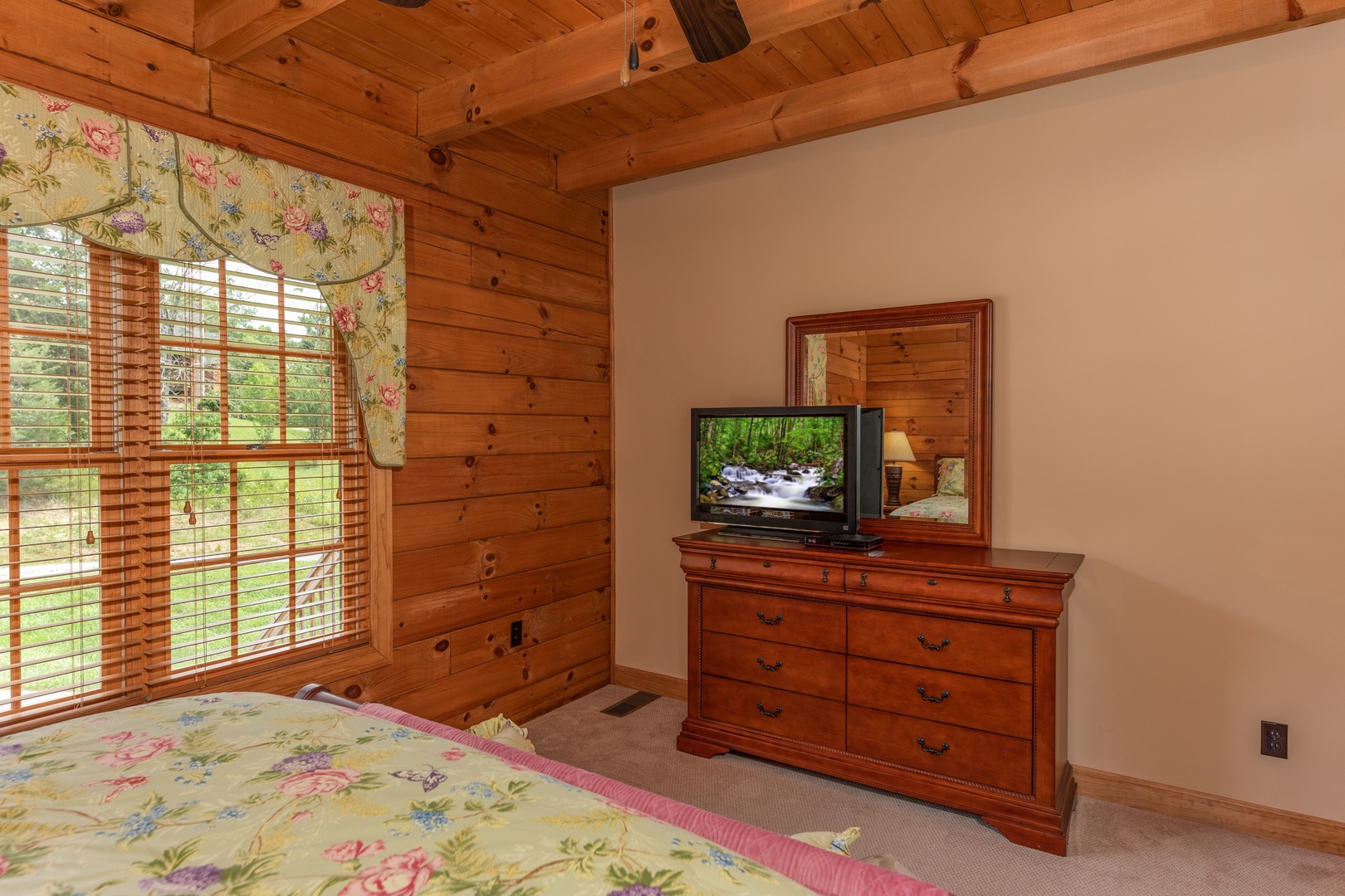 Dresser, TV, and bed in a bedroom at Mountain Lake Getaway, a 3 bedroom cabin rental located at Douglas Lake