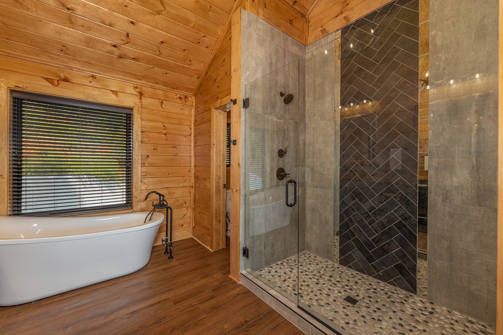 Bathroom with a soaker tub and walk in shower at Black Bears & Biscuits Lodge, a 6 bedroom cabin rental located in Pigeon Forge