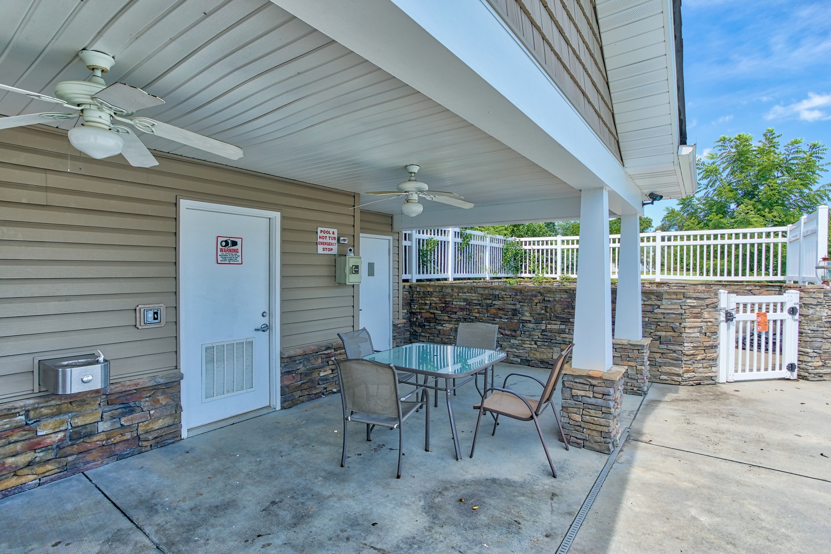 Seating at the outdoor pool deck at A Pigeon Forge Retreat, a 2 bedroom cabin rental located in Pigeon Forge