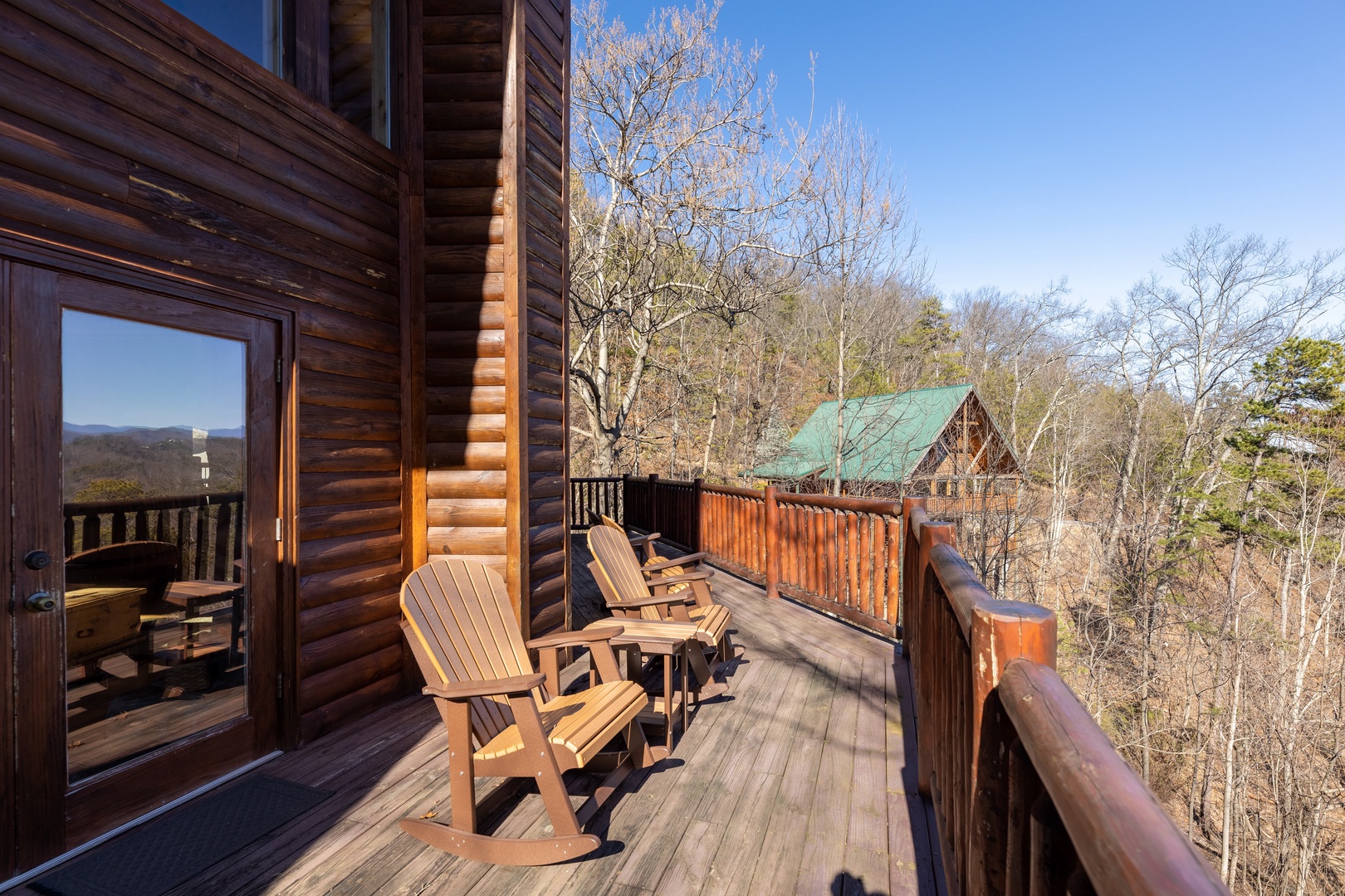Rocking chairs on a deck at Hatcher Mountain Retreat a 2 bedroom cabin rental located in Pigeon Forge