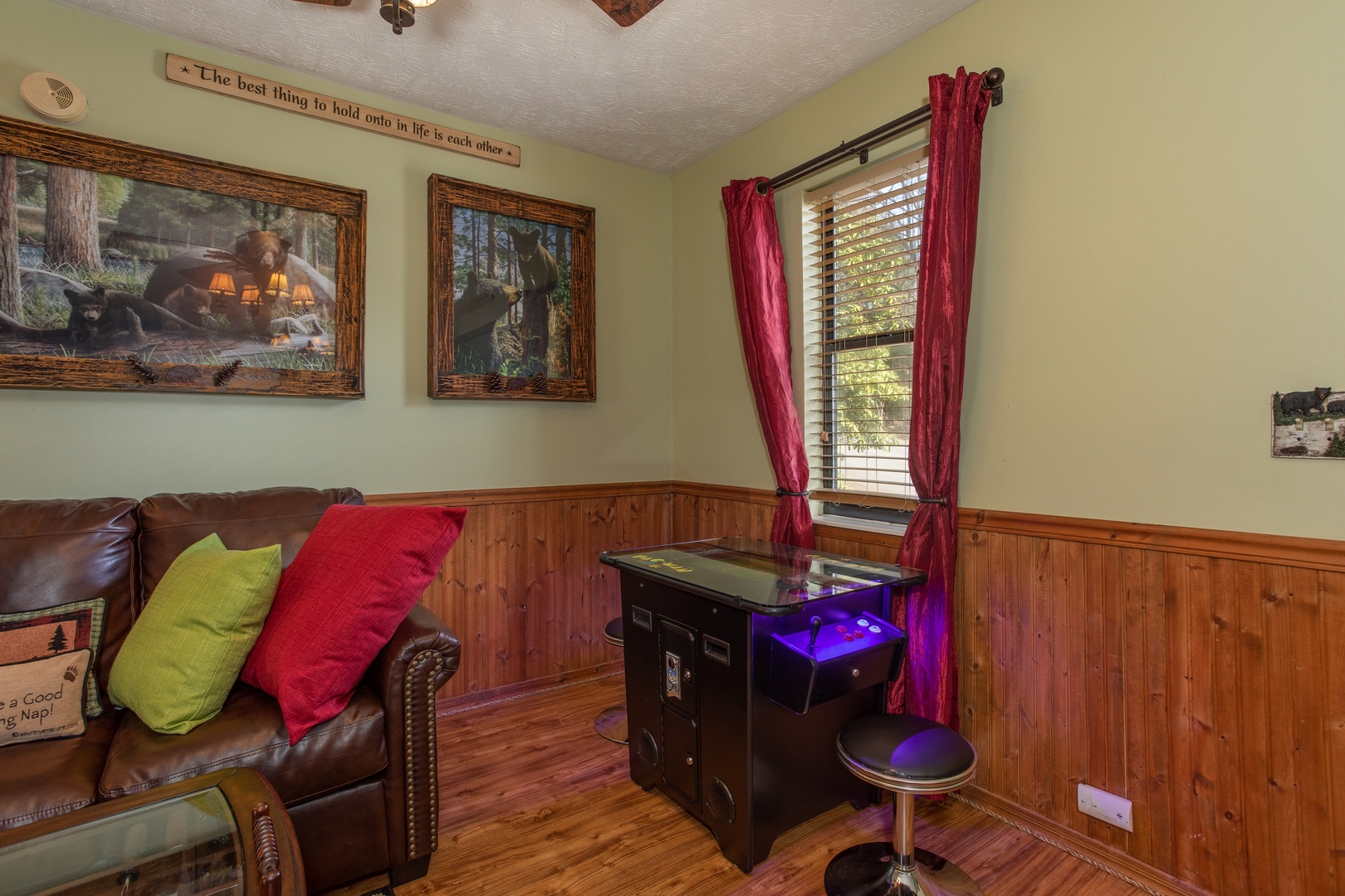 Arcade game in the living room at Bear Mountain Hollow, a 1 bedroom cabin rental located in Pigeon Forge