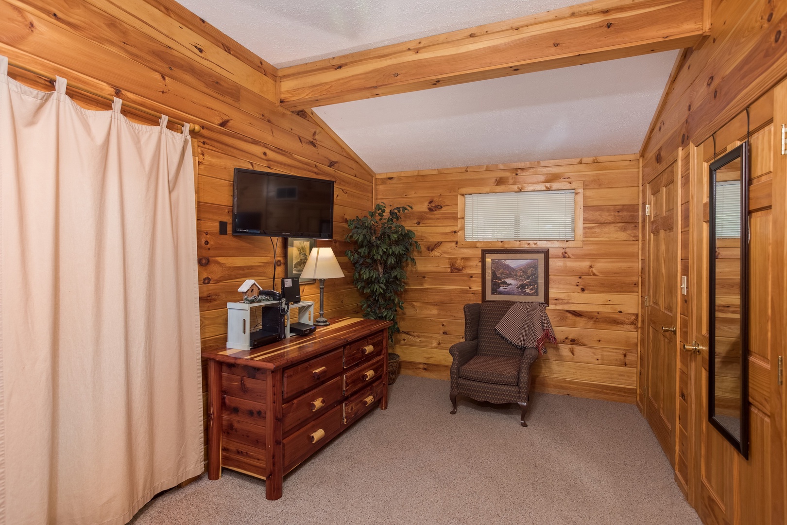 Dresser and TV in a bedroom at Bird's Eye View, a 2-bedroom cabin rental located in Gatlinburg