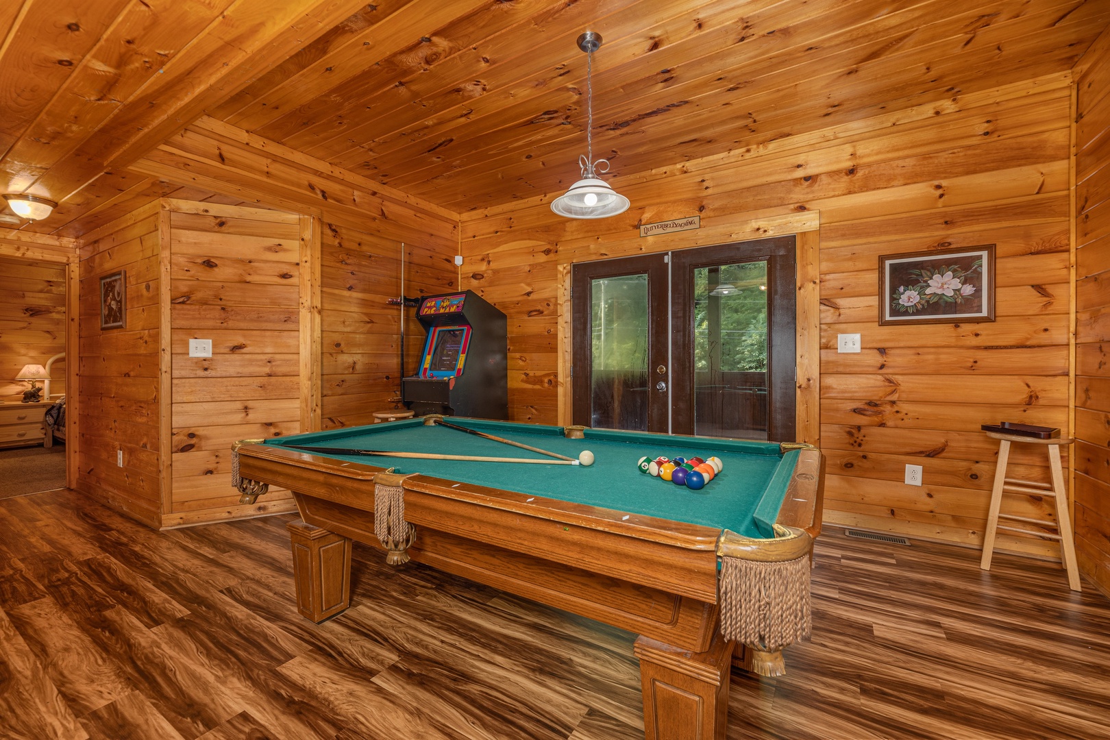 Pool table and arcade game at Family Getaway, a 4 bedroom cabin rental located in Pigeon Forge