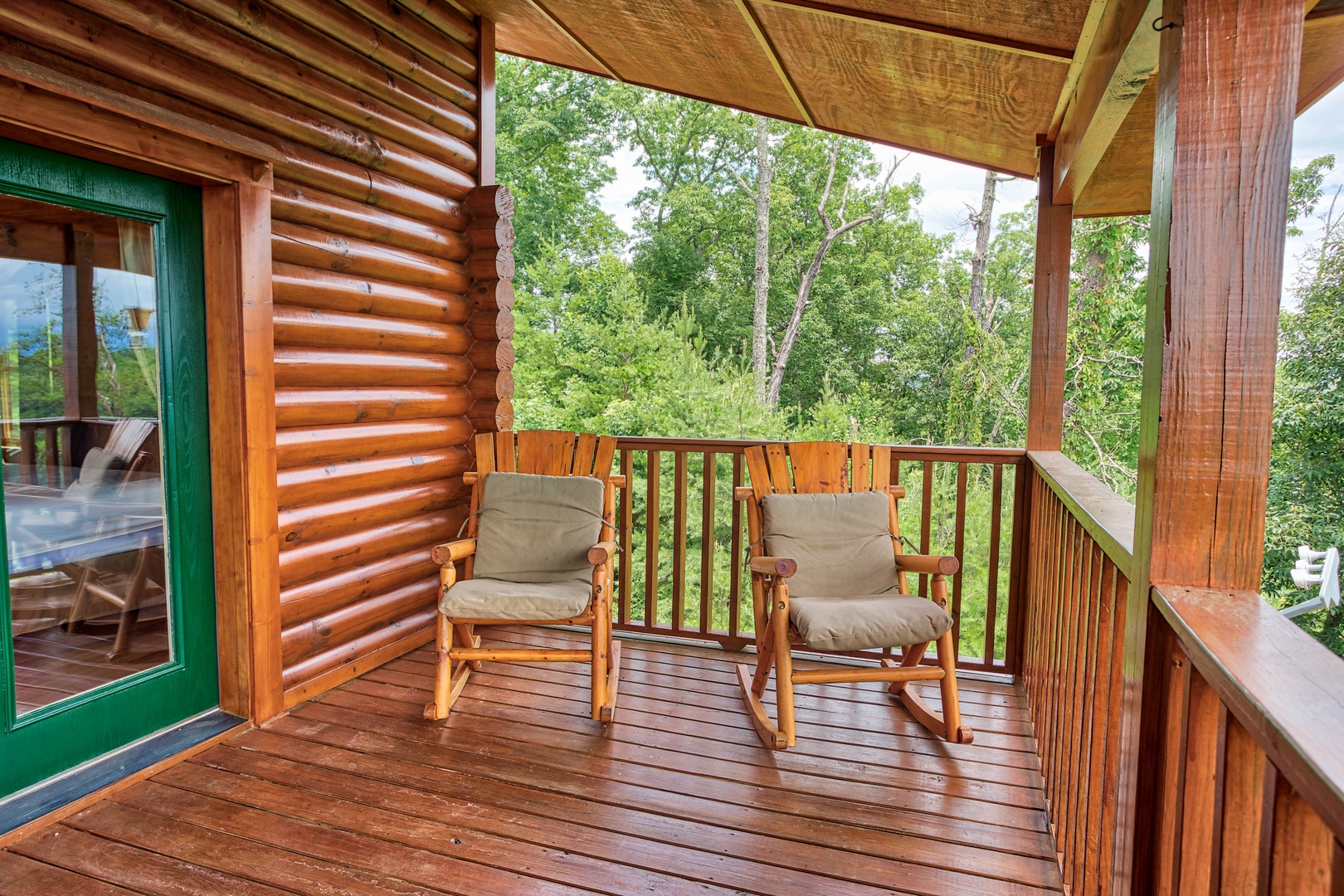 Rocking chairs on the covered deck at I Do Love Views, a 3 bedroom cabin rental located in Pigeon Forge