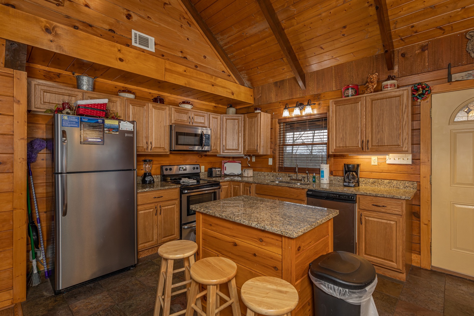 Kitchen with stainless appliances and island at Pigeon Forge Pleasures, a 3 bedroom cabin rental located in Pigeon Forge