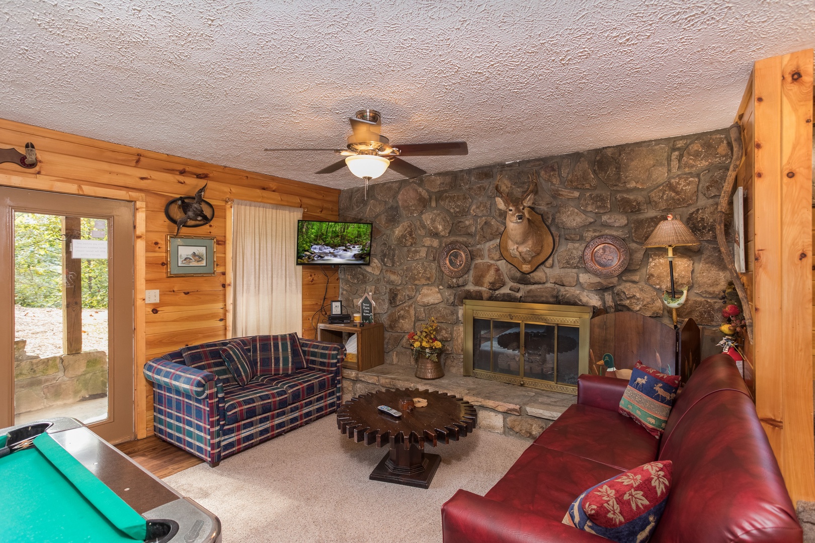 Fireplace and TV in a living room at Bird's Eye View, a 2-bedroom cabin rental located in Gatlinburg