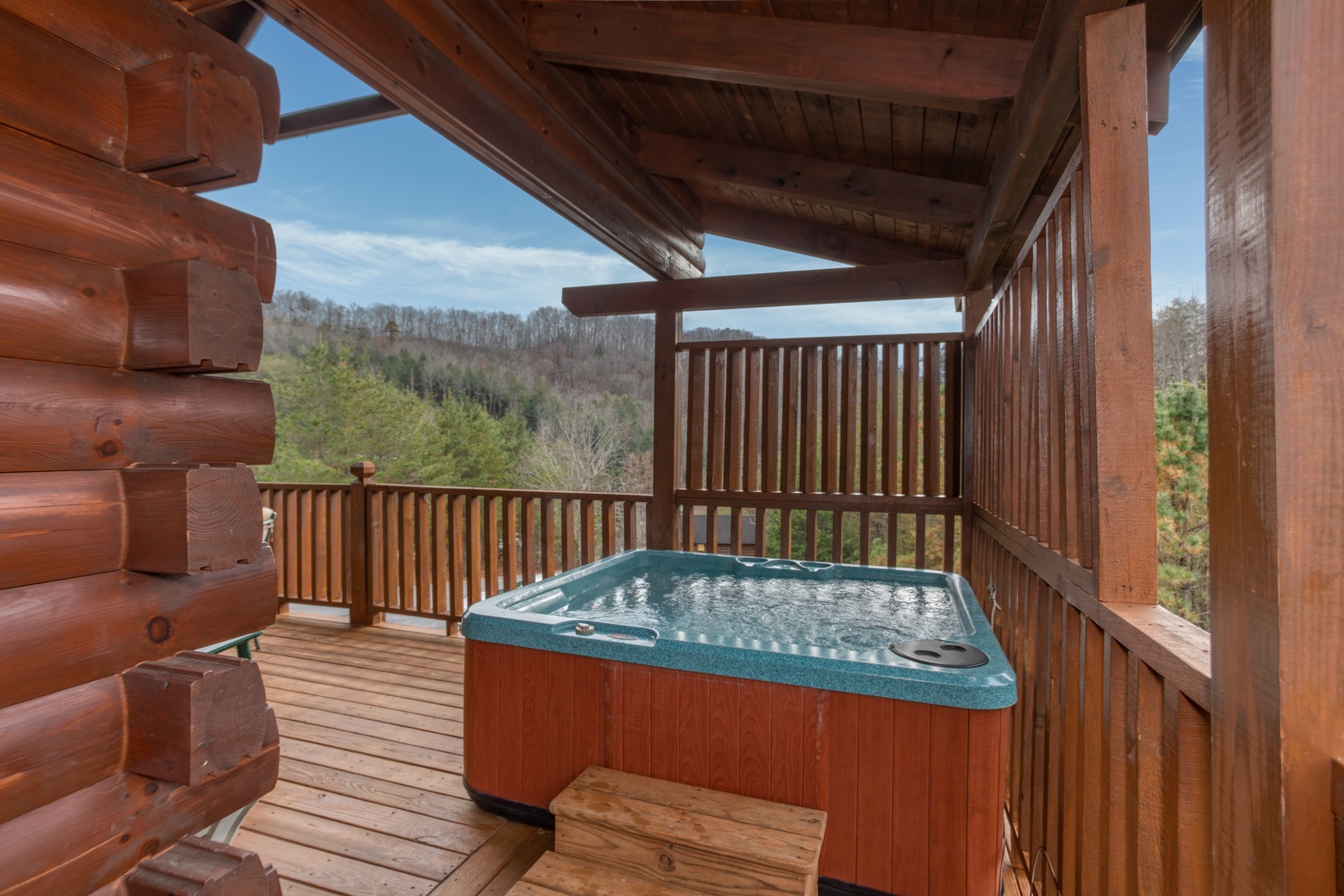 Hot tub and privacy lattice at Hibernation Station, a 3-bedroom cabin rental located in Pigeon Forge