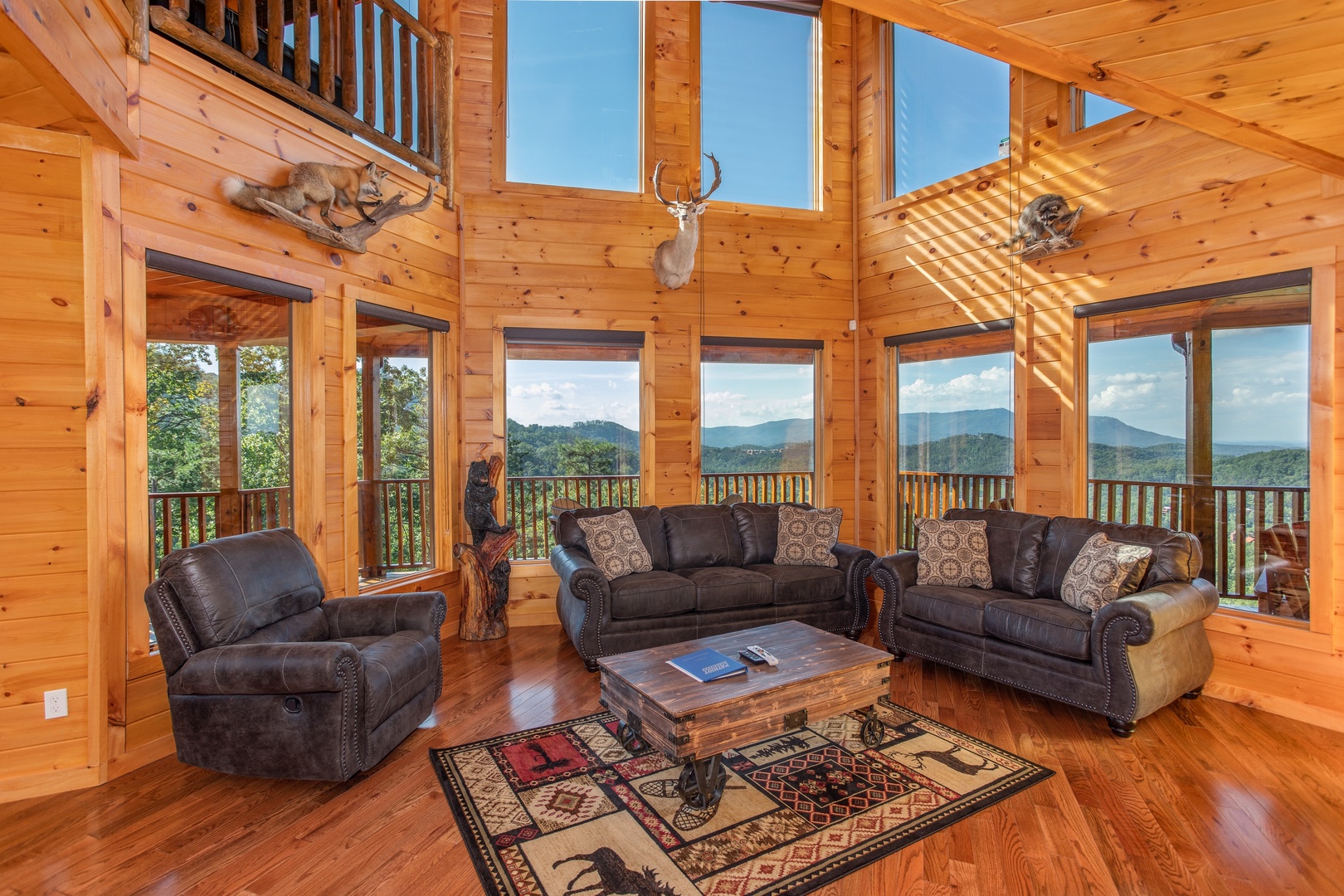 Floor to ceiling windows in a vaulted living room at Four Seasons Palace, a 5-bedroom cabin rental located in Pigeon Forge