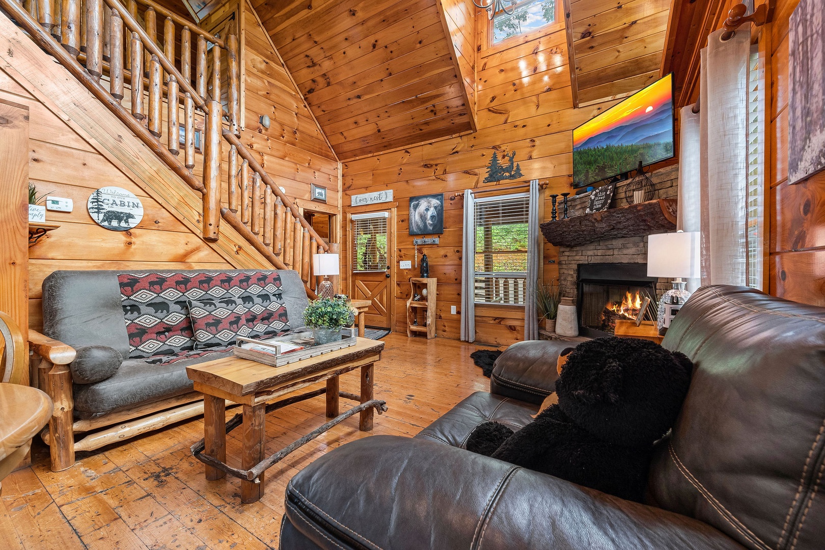 Living room with fireplace and TV at Honey Bear Haven, a 1 bedroom cabin rental located in Pigeon Forge