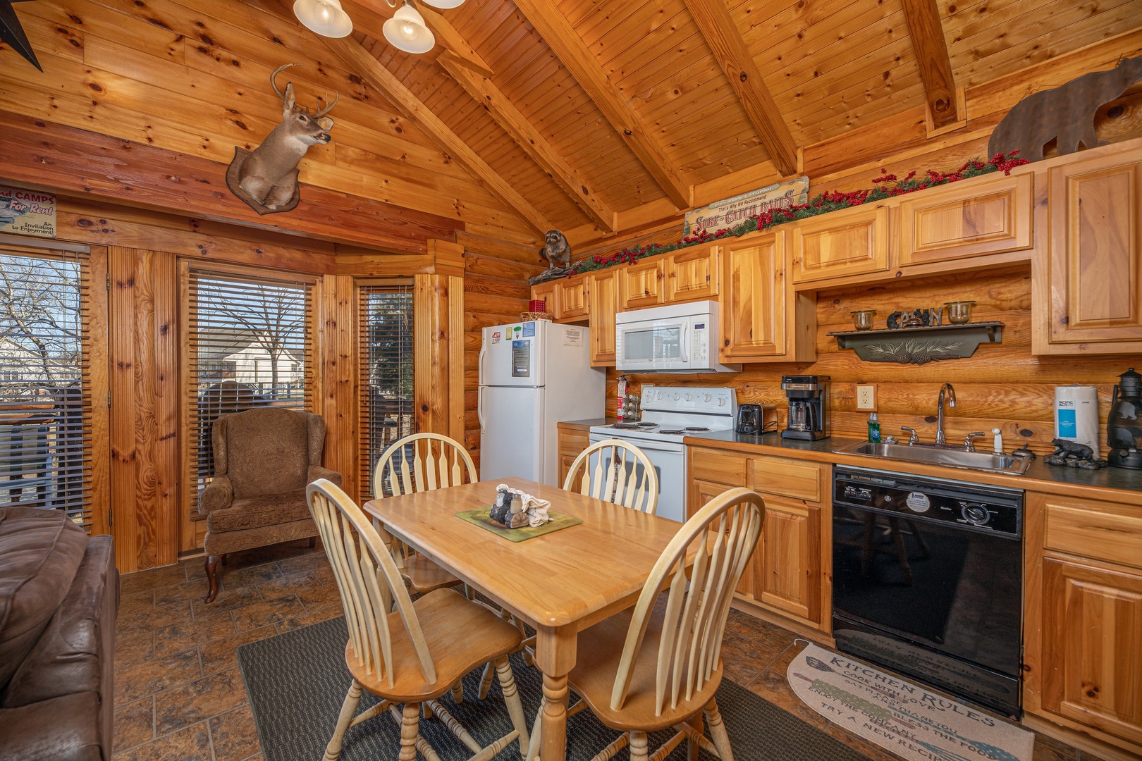 Dining table for four in a kitchen at Gone Fishin', a 2-bedroom cabin rental located in Pigeon Forge