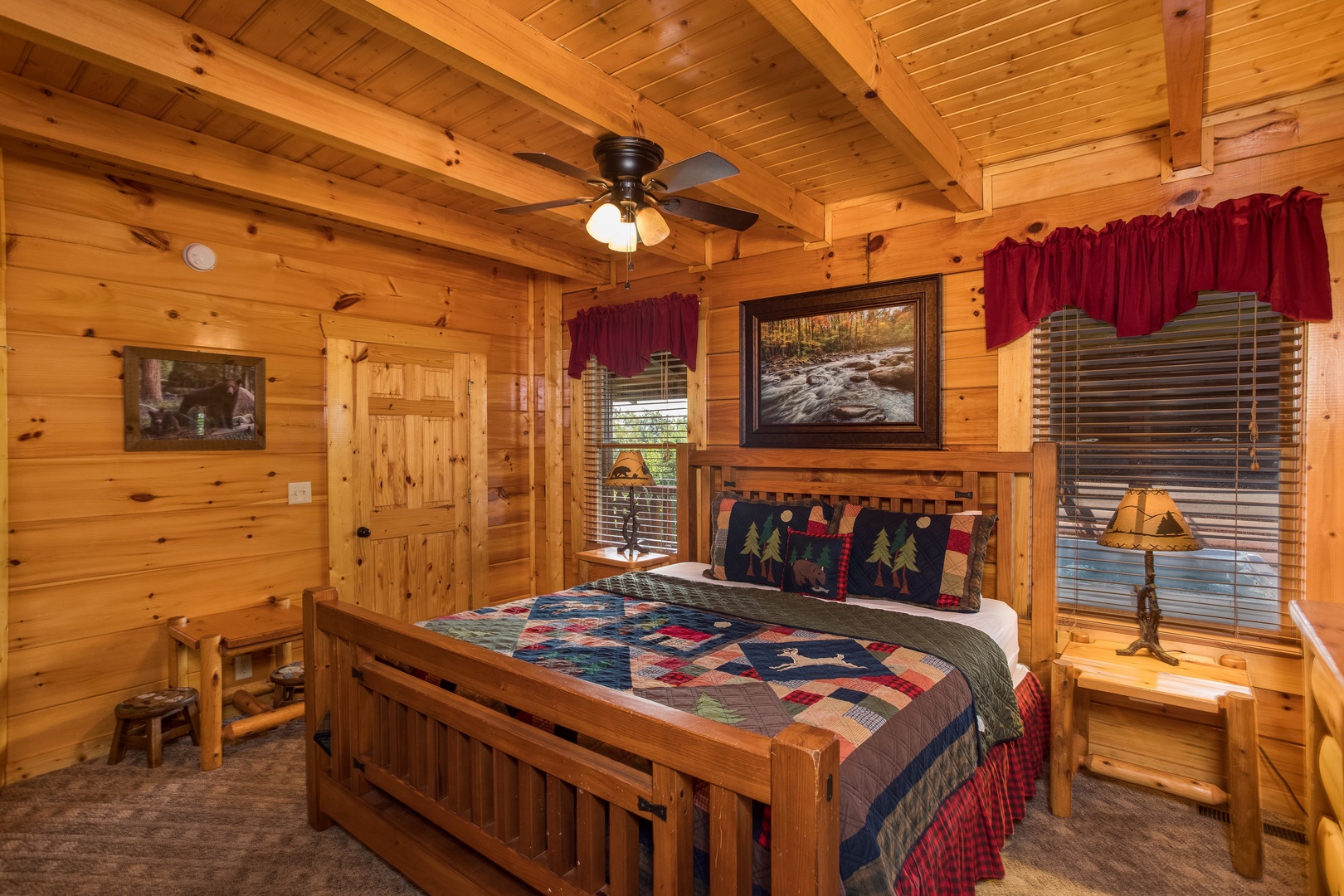 Bedroom with a bed, night stands, and lamps at Graceland, a 4-bedroom cabin rental located in Pigeon Forge