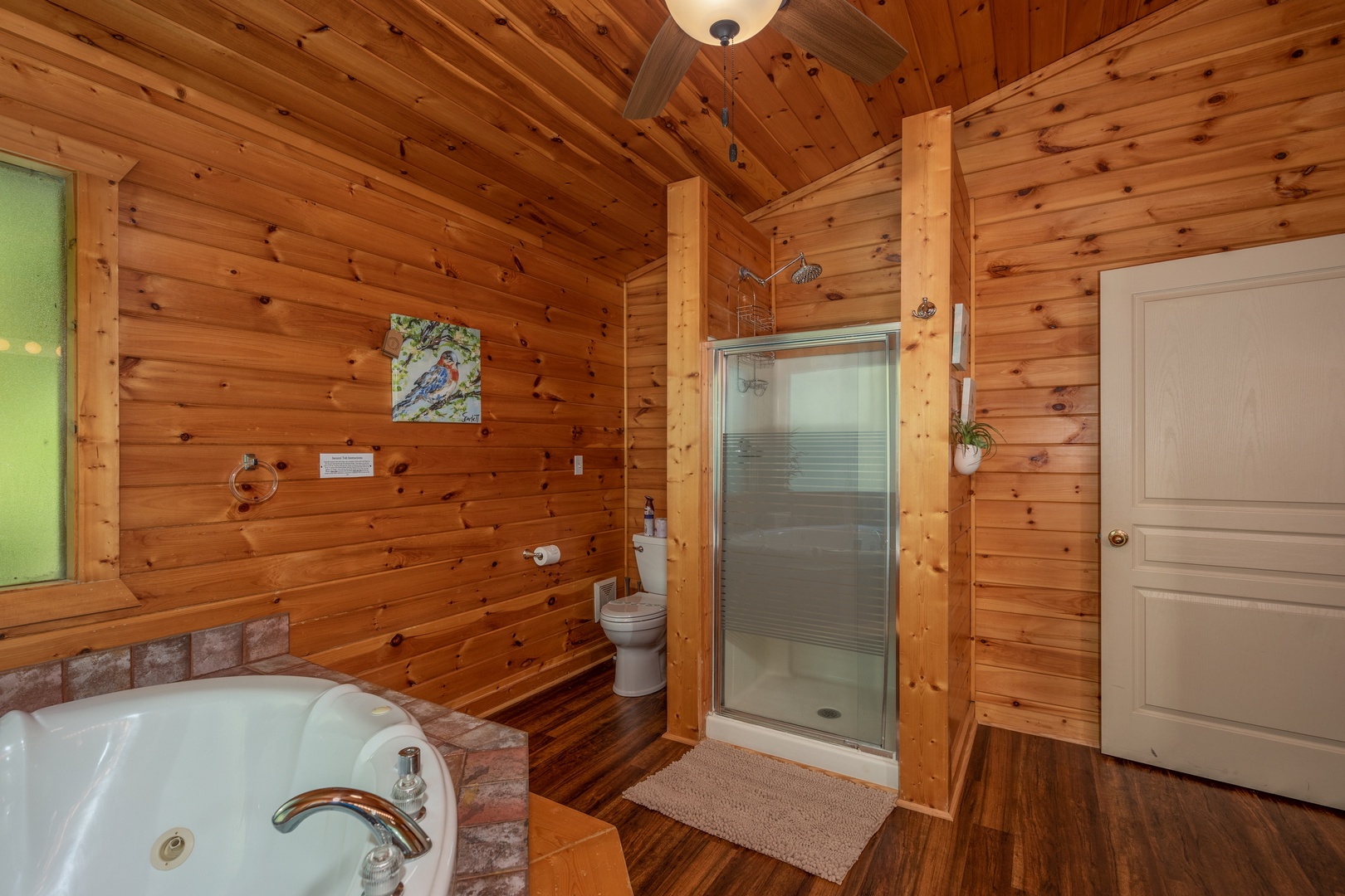 Bathroom with a jacuzzi tub and separate shower at Hawk's Heart Lodge, a 3 bedroom cabin rental located in Pigeon Forge