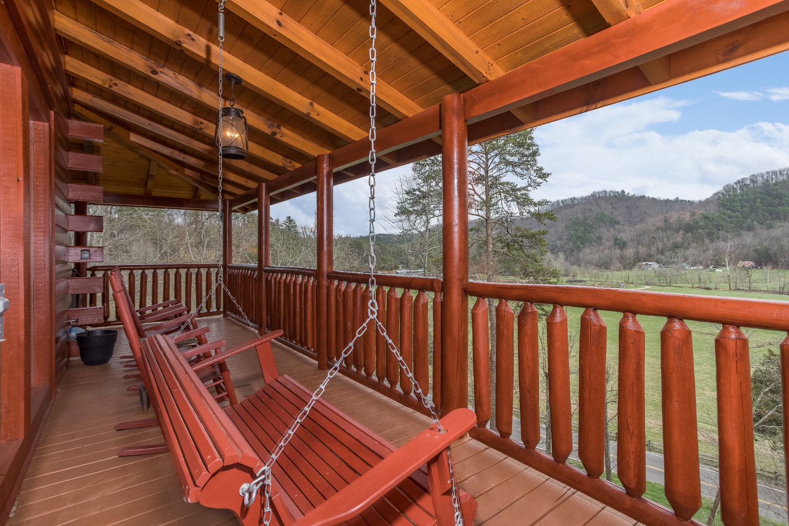 Porch swing on a covered porch at Mountain View Meadows, a 3 bedroom cabin rental located in Pigeon Forge