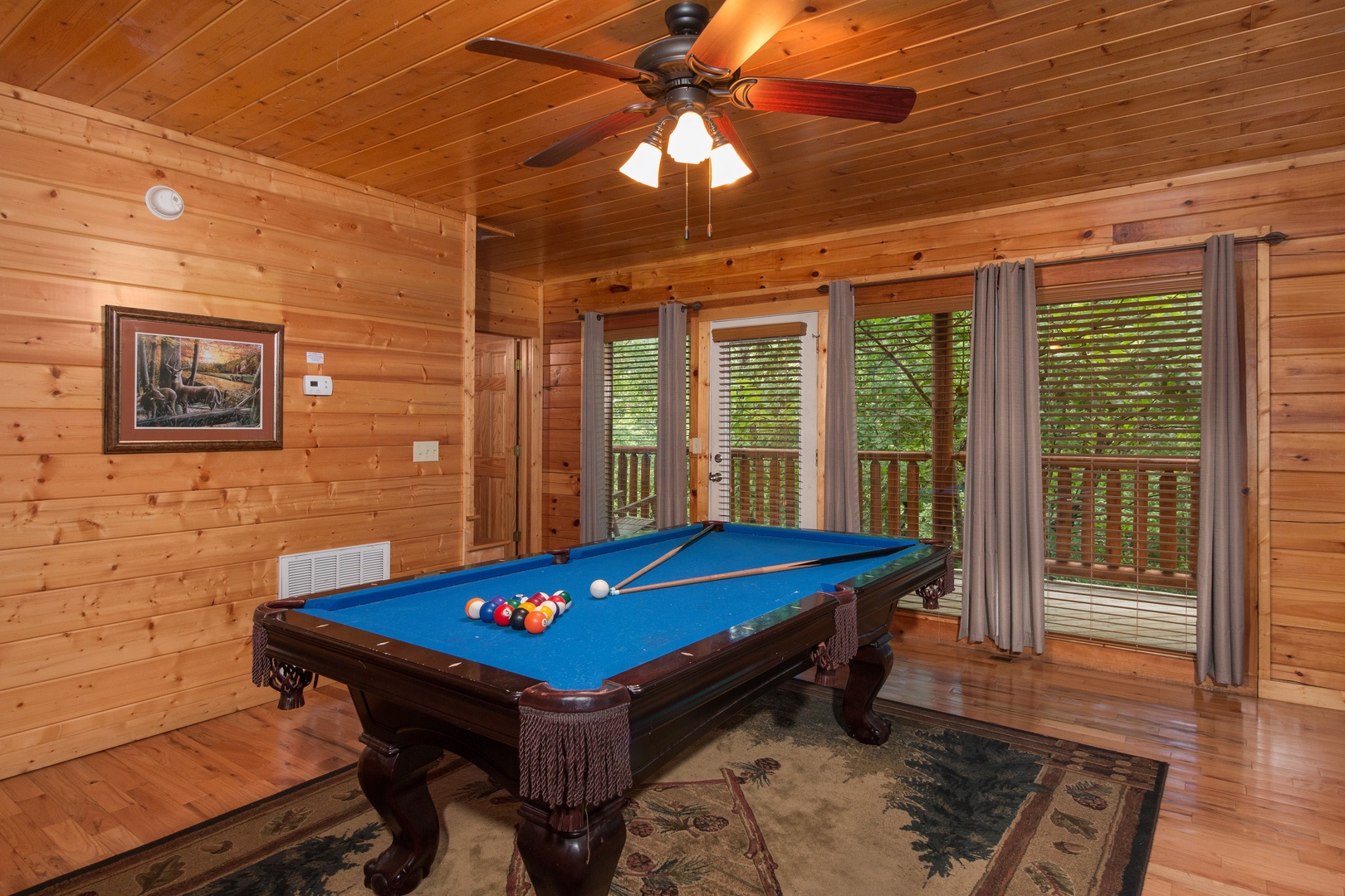 Pool table and deck entrance at Family Ties Lodge