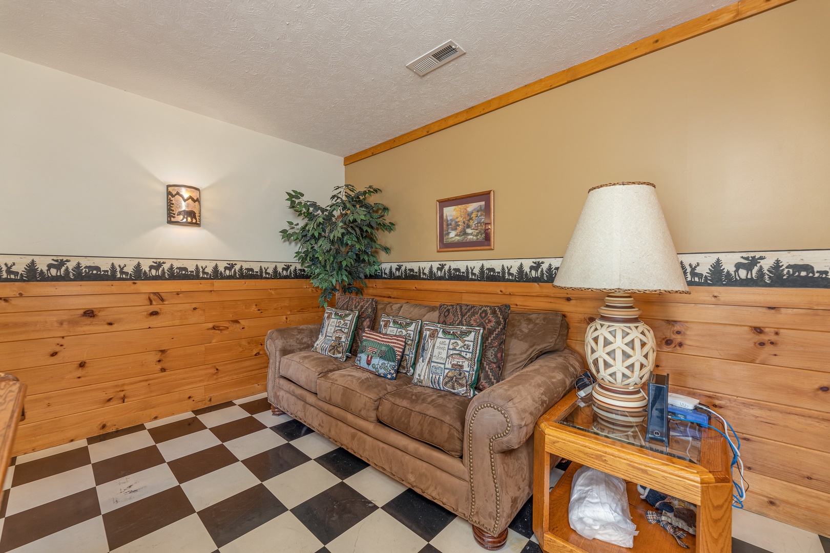 Sofa in the game room at Cub's Crossing, a 3 bedroom cabin rental located in Gatlinburg