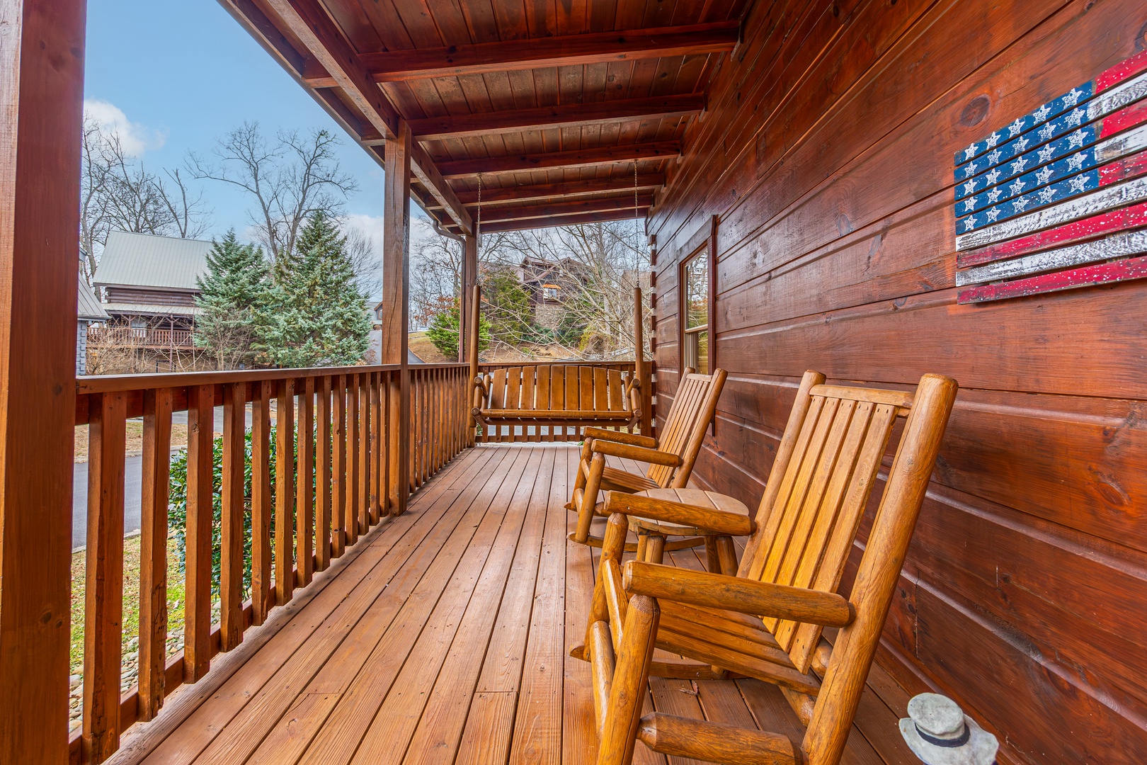 Seating on covered deck at Livin' Simple, a 2 bedroom cabin rental located in Pigeon Forge