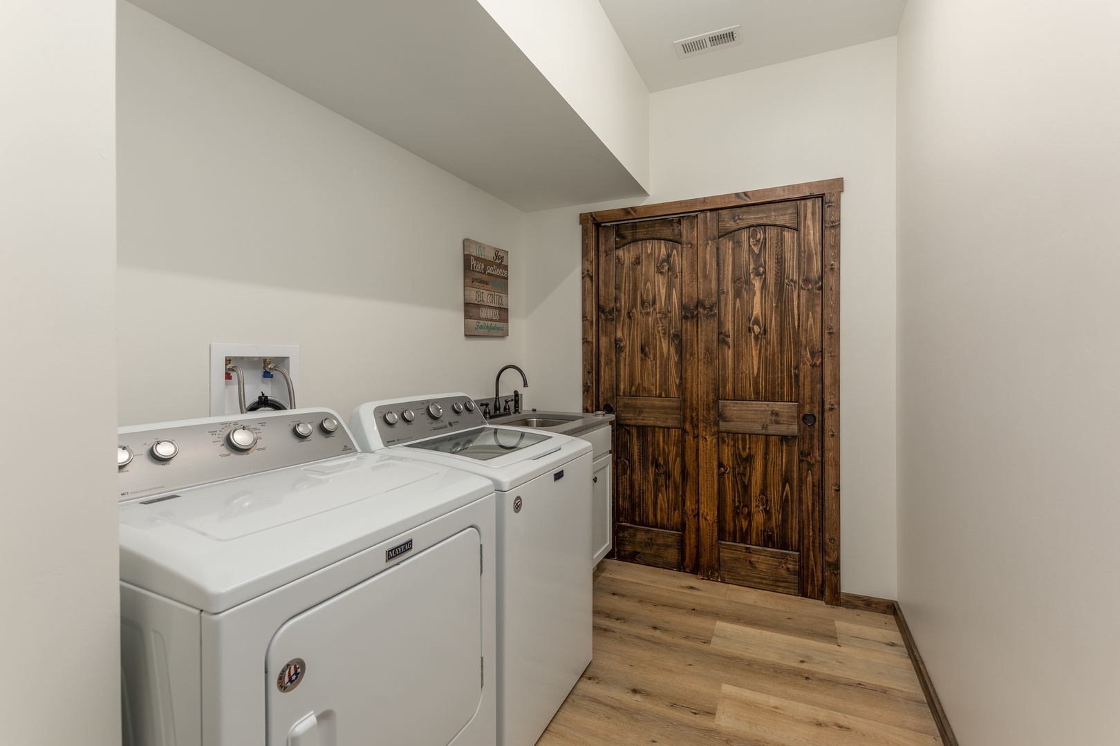 Laundry room with utility sink at Mountain Celebration, a 4 bedroom cabin rental located in Gatlinburg