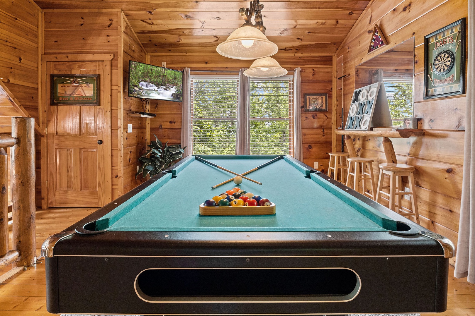 Pool table and TV in the game space at Honey Bear Haven, a 1 bedroom cabin rental located in Pigeon Forge