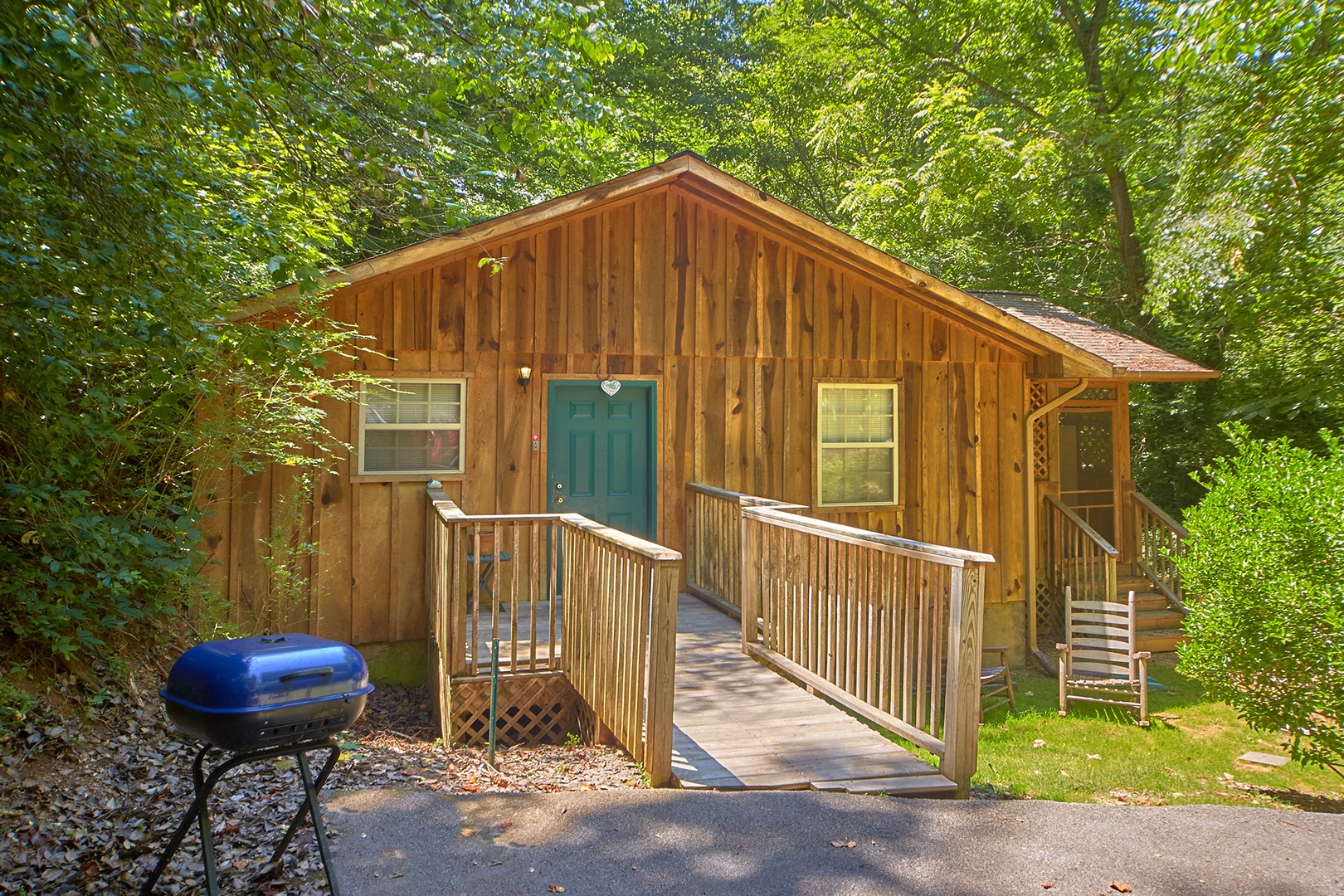 Grill, parking area, and entry way deck at Dream Catcher, a 1-bedroom cabin rental located in Pigeon Forge