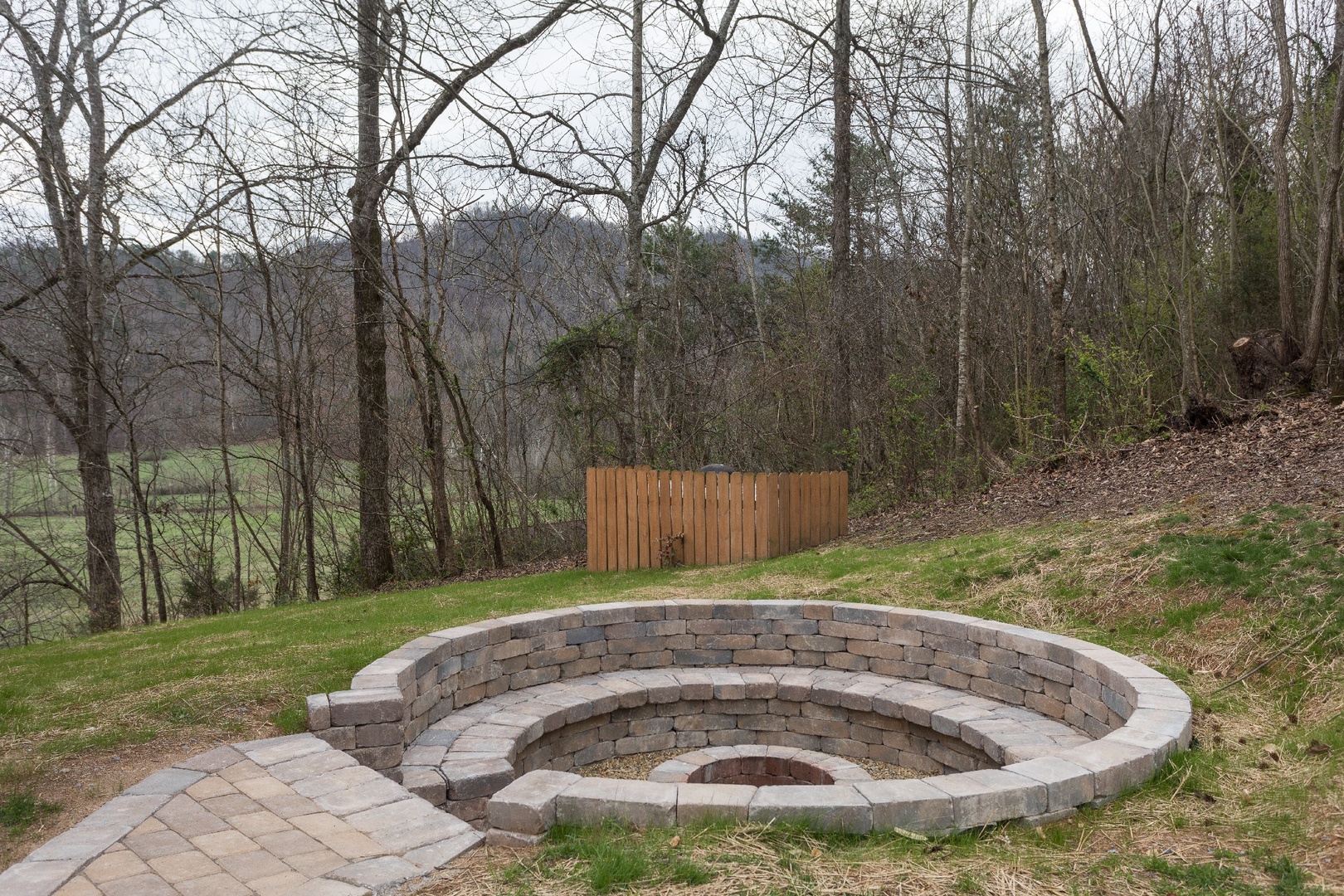 Custom stone work fire pit at Mountain View Meadows, a 3 bedroom cabin rental located in Pigeon Forge