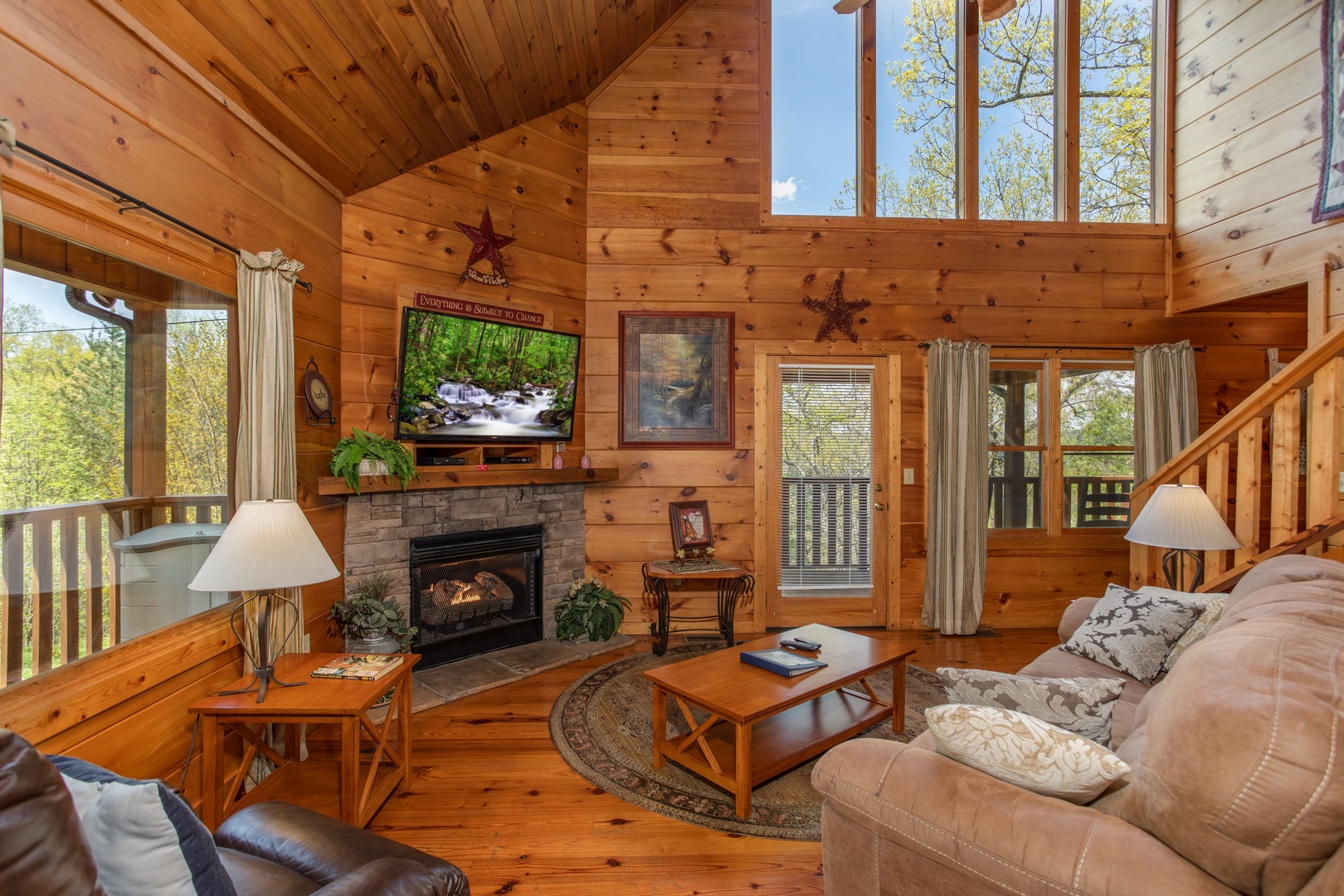 Living room with fireplace and TV at Hillside Haven, a 1 bedroom cabin rental located in Pigeon Forge