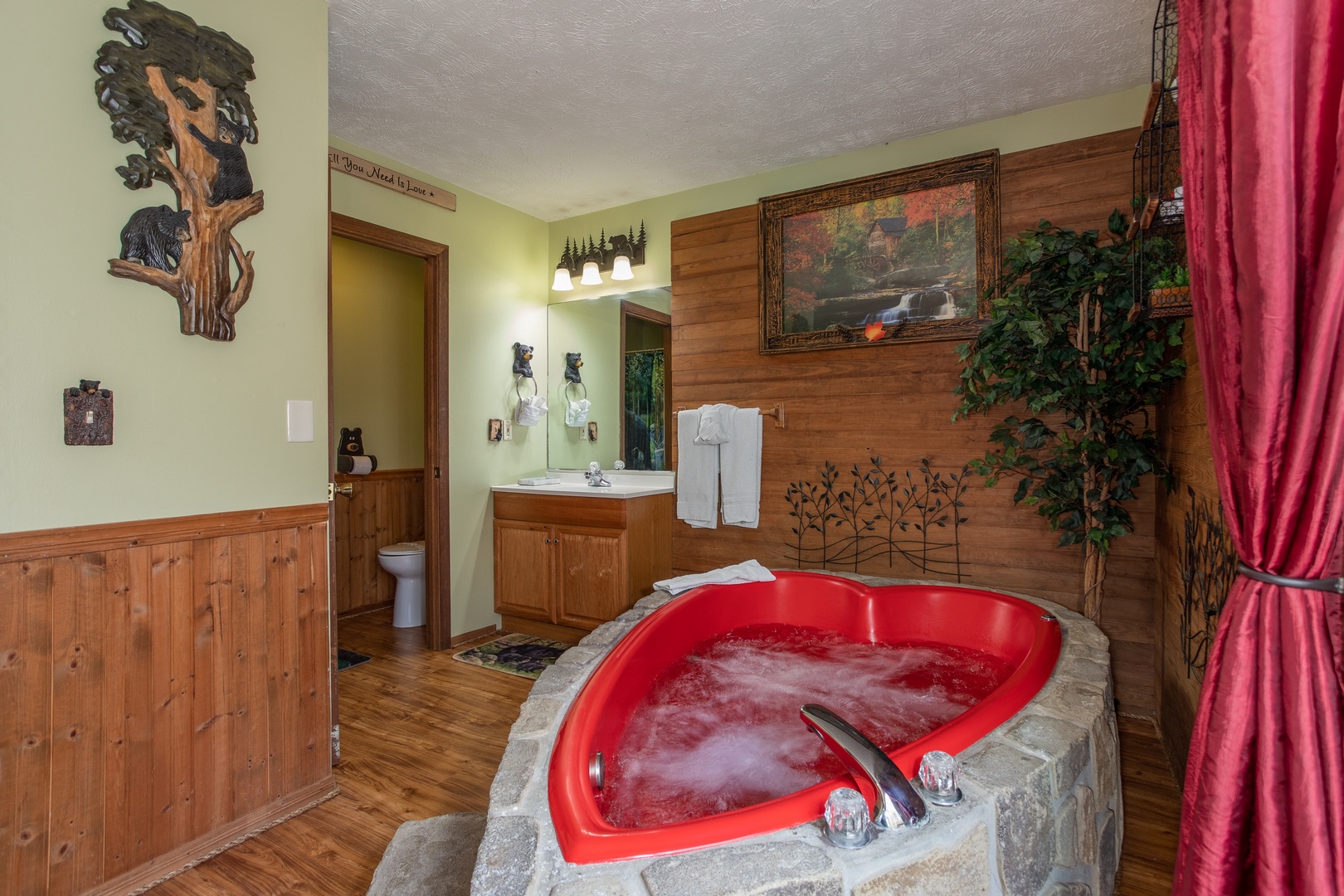 Heart shaped jacuzzi in the bedroom space at Bear Mountain Hollow, a 1 bedroom cabin rental located in Pigeon Forge