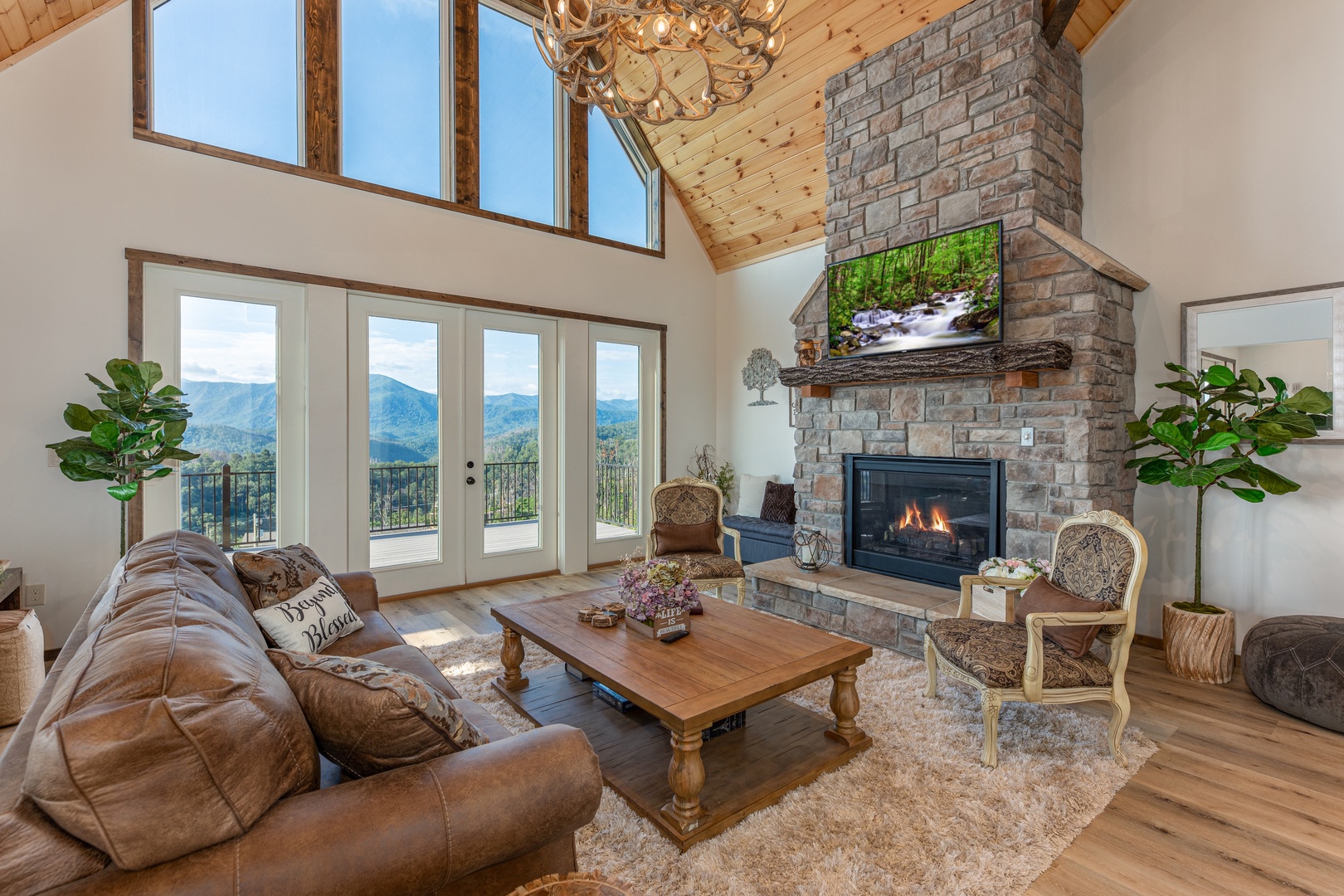 Living room with mountain view, fireplace, and TV at Mountain Celebration, a 4 bedroom cabin rental located in Gatlinburg