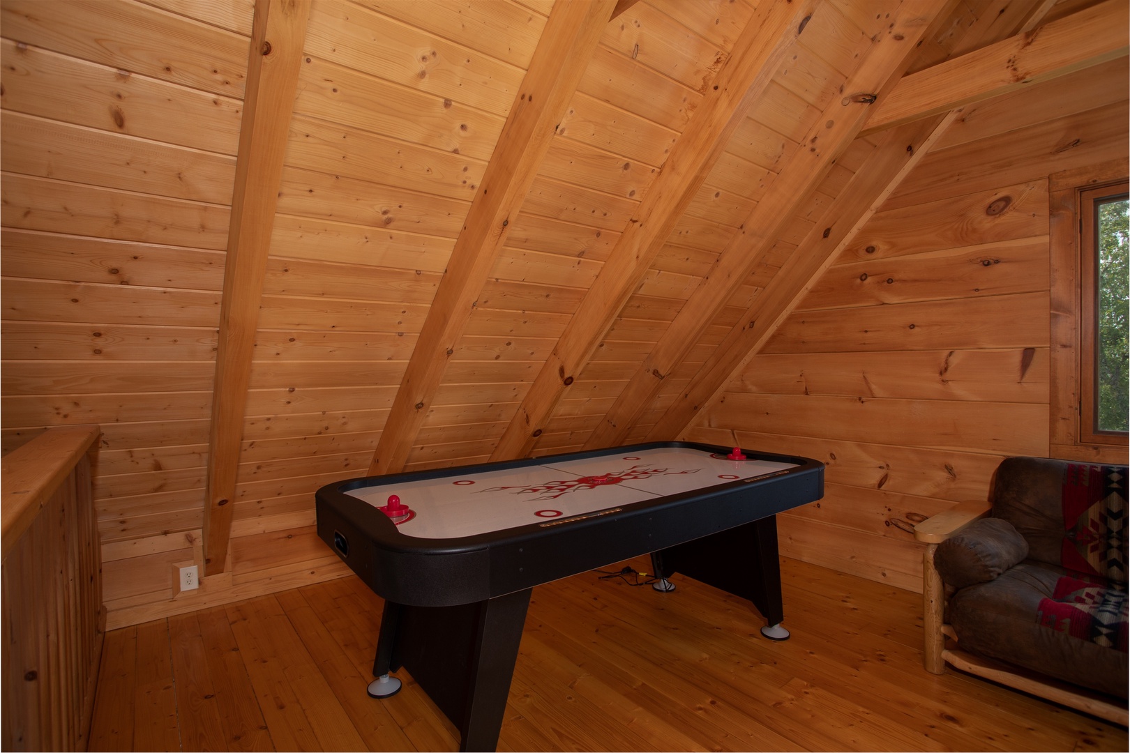 Air hockey table in the game loft at Cedar Creeks, a 2-bedroom cabin rental located near Douglas Lake