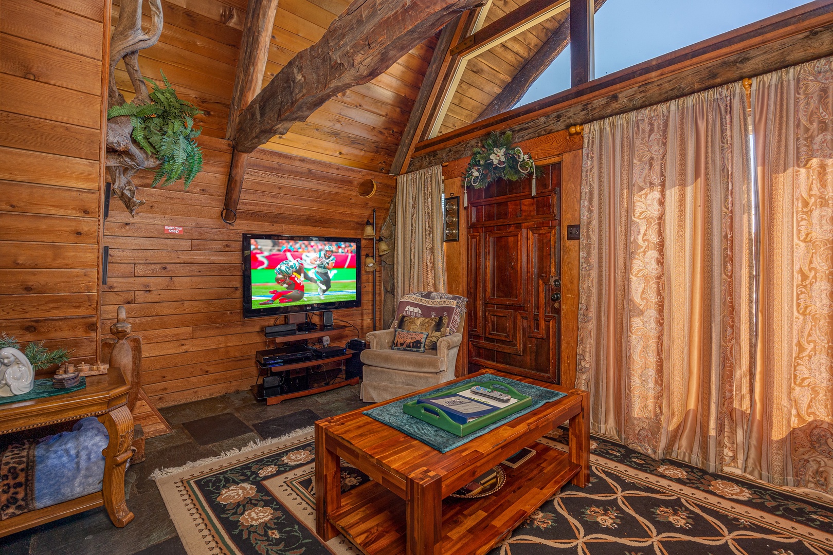 Coffee table and television at Ever After, a 1 bedroom cabin rental located in Gatlinburg