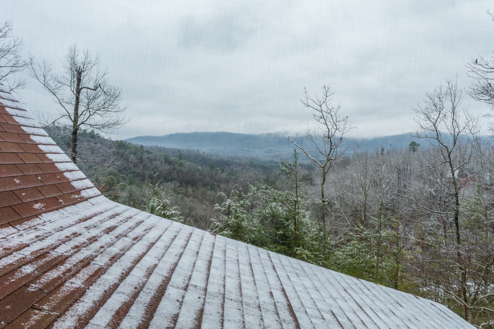 A dusting of snow and the Smoky Mountains at Alpine Romance, a 2 bedroom cabin rental located in Pigeon Forge