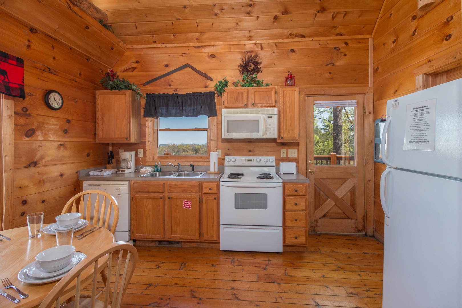 Kitchen with white appliances at Lumber Jack Lodge, a 1 bedroom cabin rental located in Gatlinburg