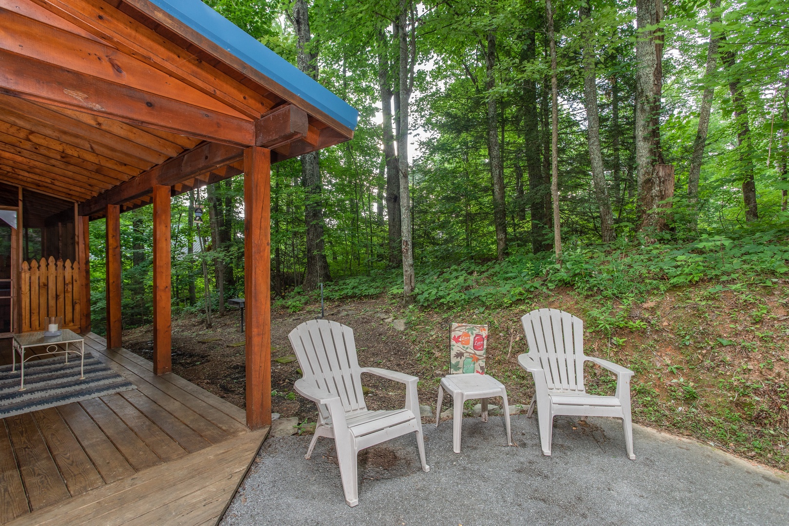 Two plastic Adirondack chairs on a patio at Lazy Mountain Retreat, a 1 bedroom cabin rental located in Gatlinburg