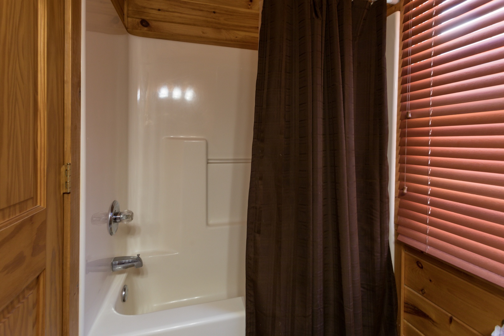 Bathroom with a tub and shower at Four Seasons Lodge, a 3-bedroom cabin rental located in Pigeon Forge