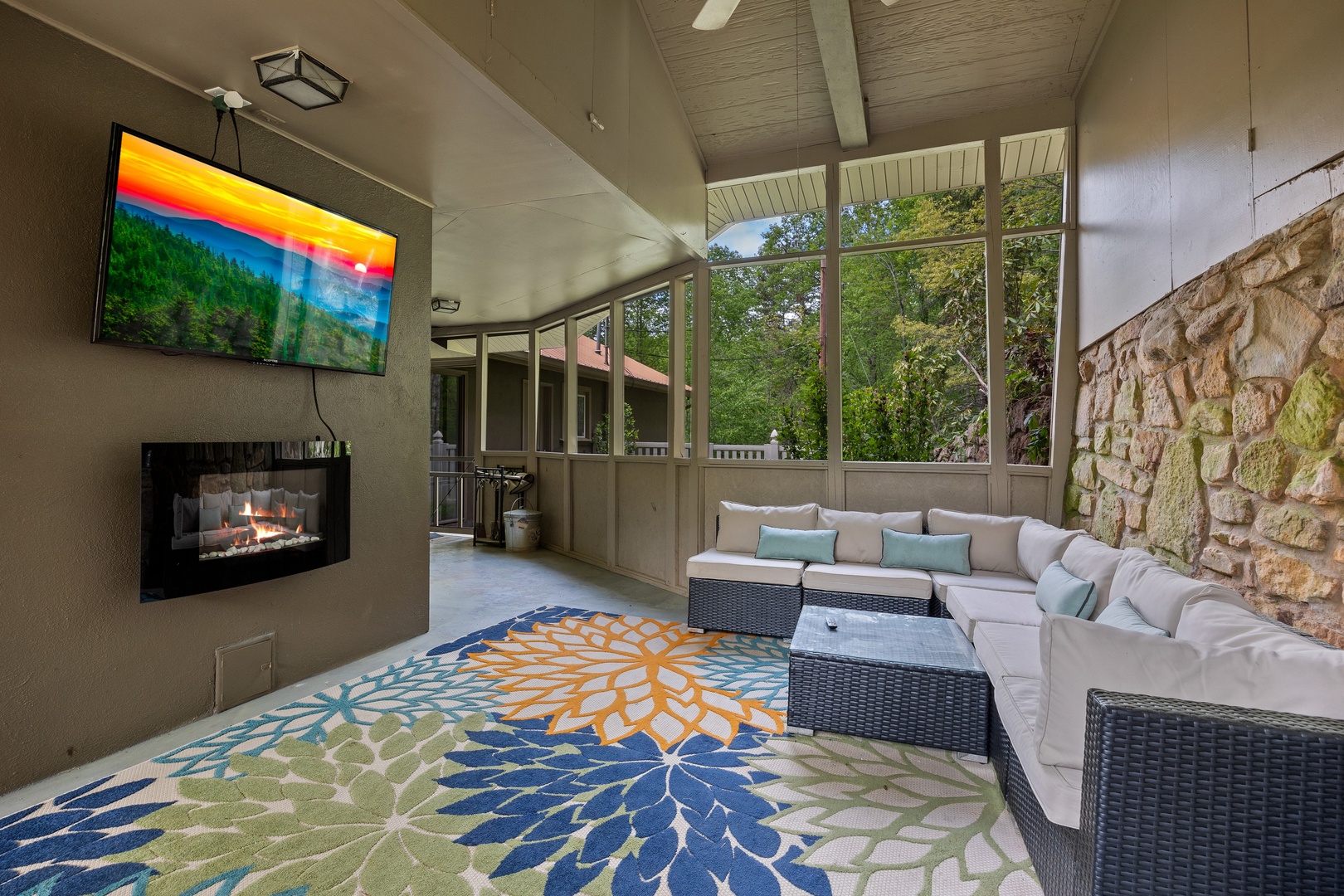Outdoor flat screen, sectional, and fireplace at Buckhorn Springs
