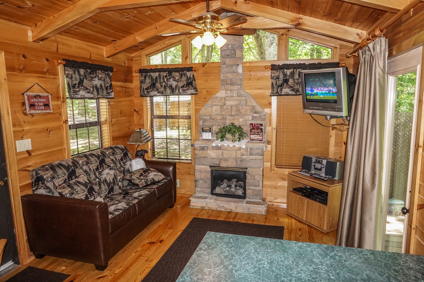 Living room with stone fireplace at Seclusion, a 1 bedroom cabin rental located in Gatlinburg