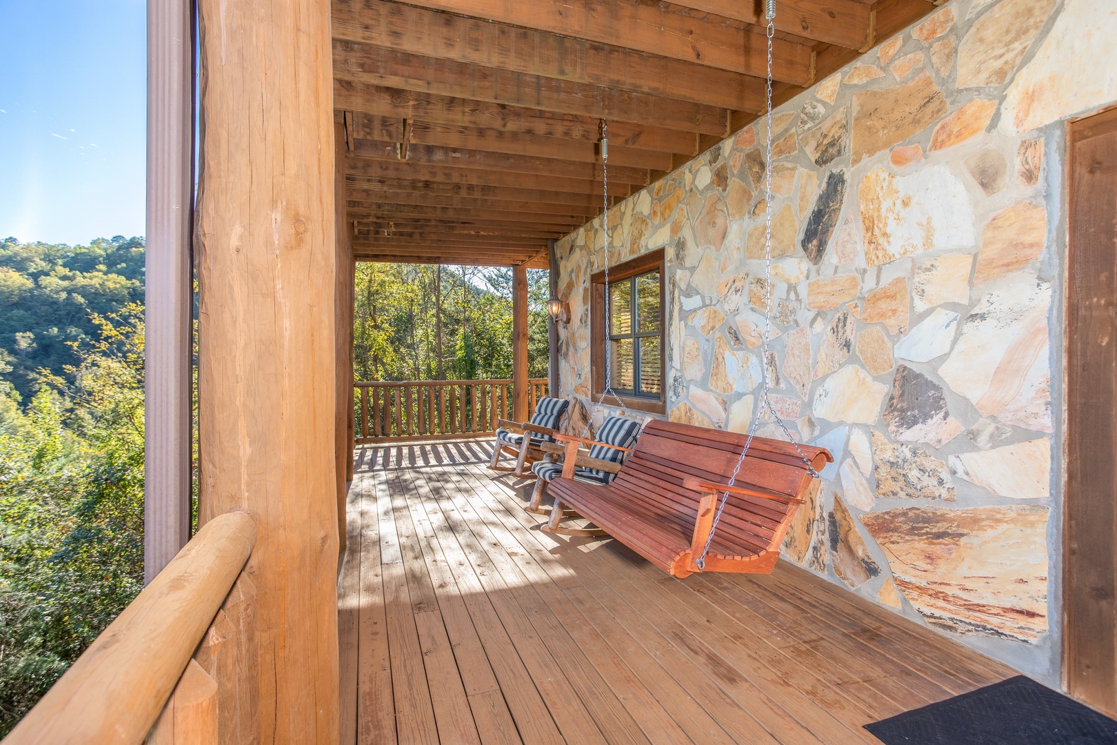 Swing on the lower deck at Great View Lodge, a 5-bedroom cabin rental located in Pigeon Forge
