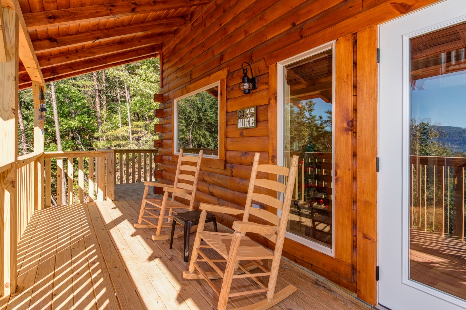 Rocking chairs on a covered deck at Canyon Camp Falls, a 2 bedroom cabin rental located in Pigeon Forge