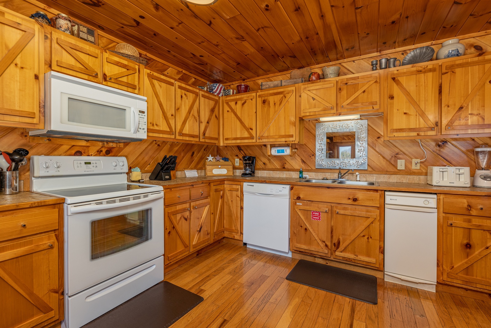 Kitchen with white appliances at Hatcher Mountain Retreat a 2 bedroom cabin rental located in Pigeon Forge