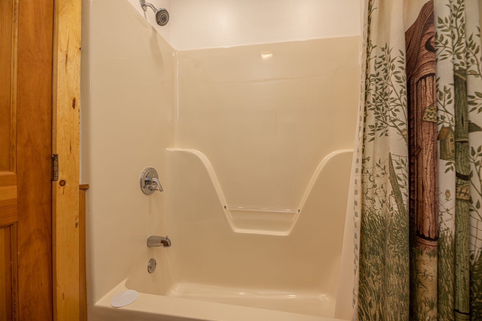 Tub and shower in a bathroom at Southern Charm, a 2 bedroom cabin rental located in Pigeon Forge
