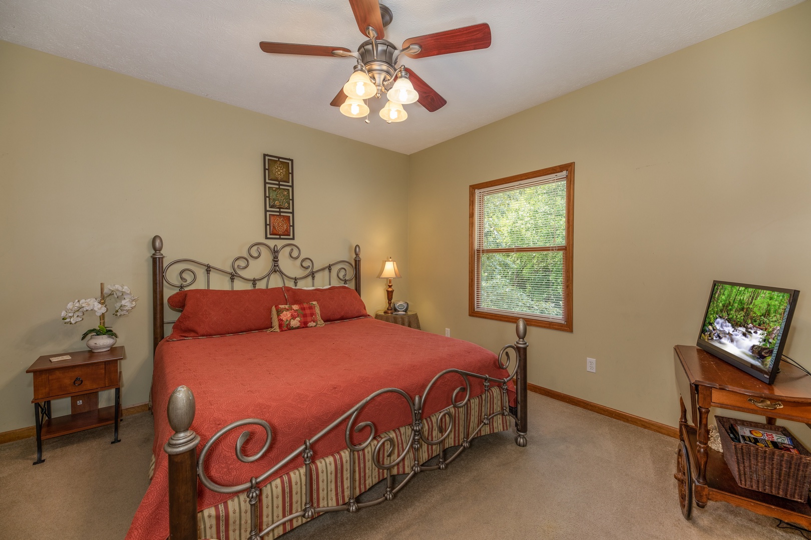 Bedroom with a king bed, two tables, a lamp, and a TV at Amazing Memories, a 3 bedroom cabin rental located in Pigeon Forge