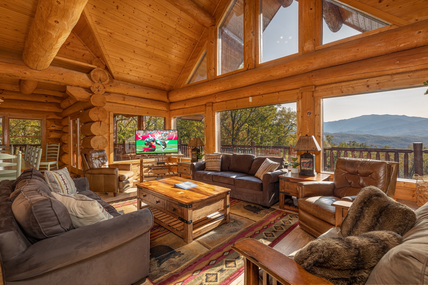 TV and mountain views in the living room at Grizzly's Den, a 5 bedroom cabin rental located in Gatlinburg